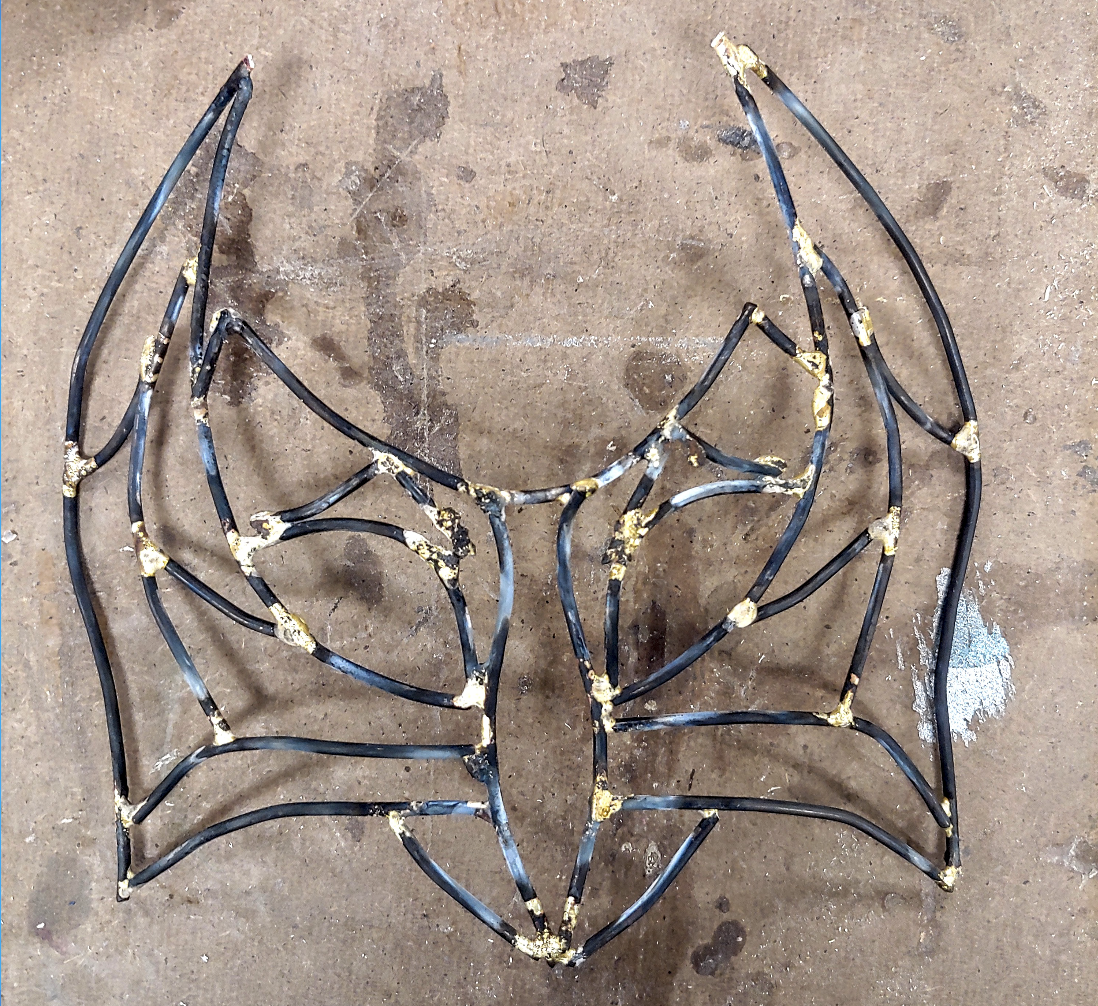 Brazing Project This mask was made using annealed wire that was cut and bent into shape. The joints were then brazed together. The mask is primed, sprayed with metallic gold spray paint, and topped with yellow and red FEV.