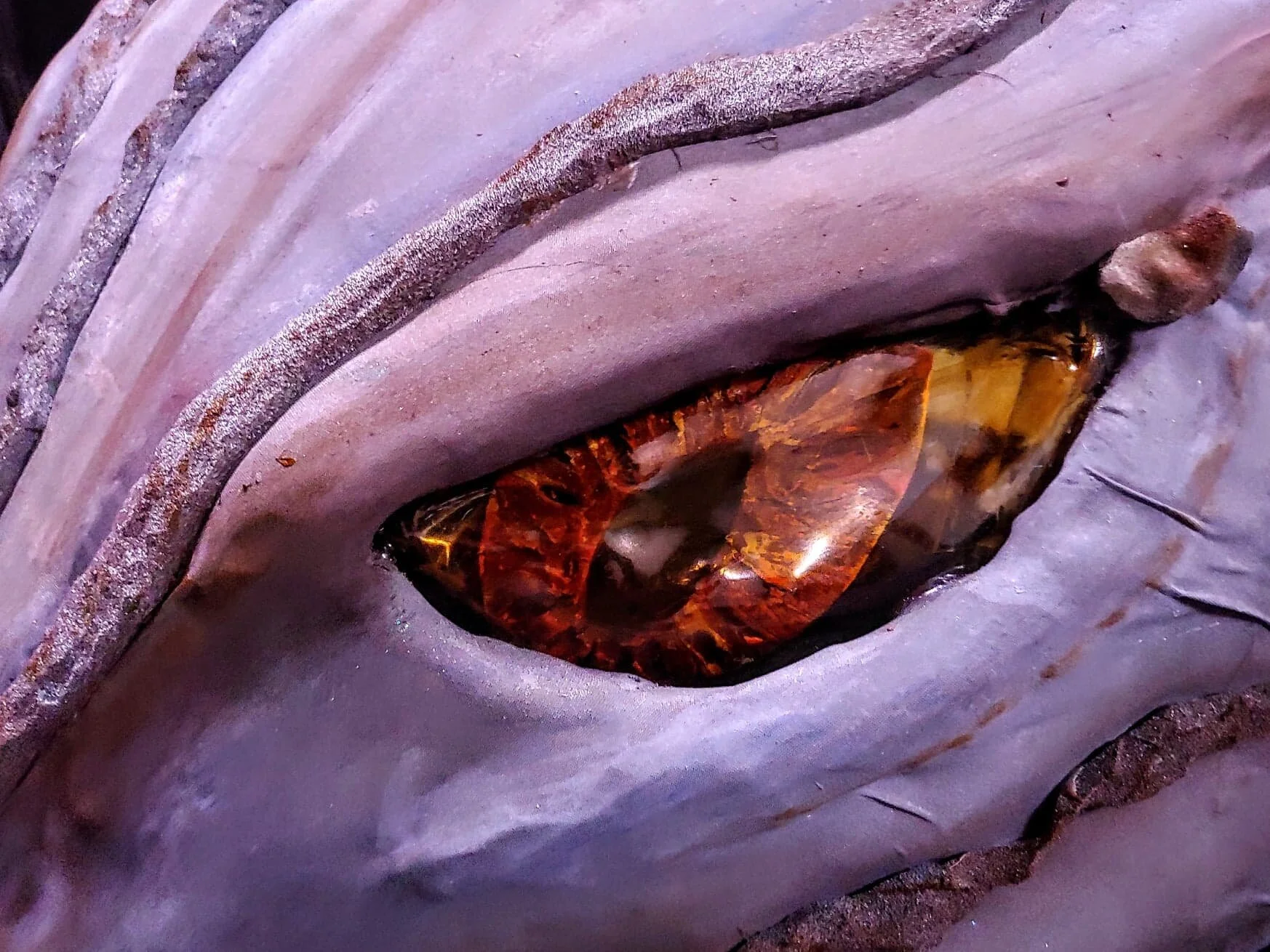 Eye made of EVA and painted. Plexiglass was heated and shaped to the eye and tinted yellow with FEV