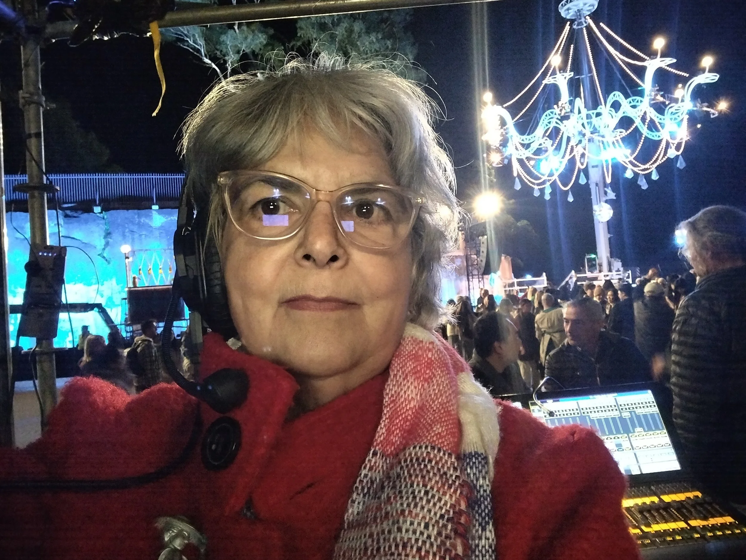 woman in red coat with crowd in background