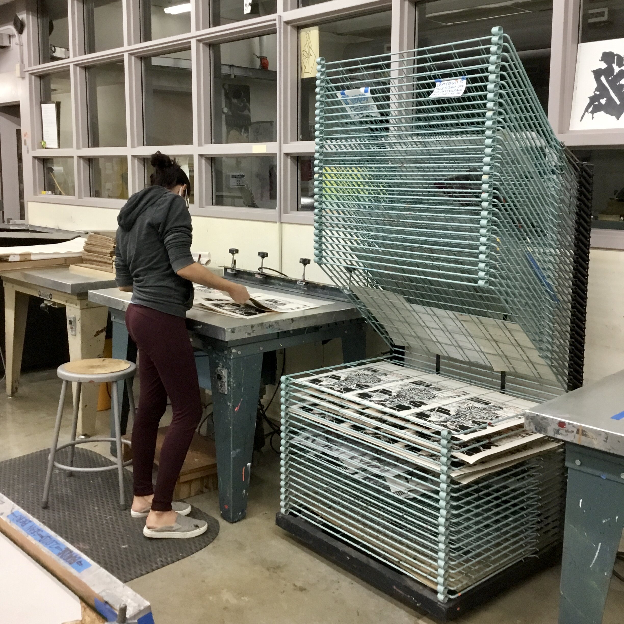 Alissa looking through prints for misprints and mistakes