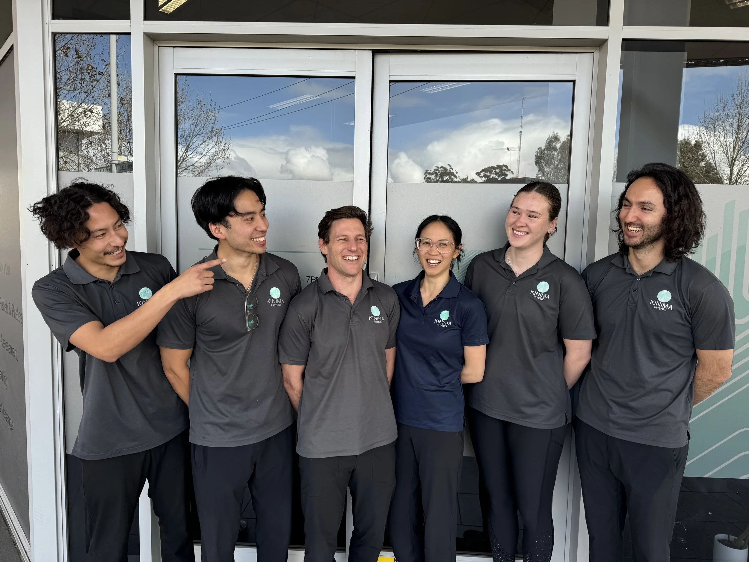 Kinima Physio Team Sharing a Joke in Front of the Clinic