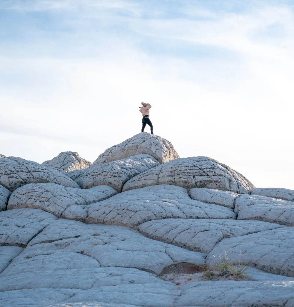 Two adventurers on a desert rock formation.