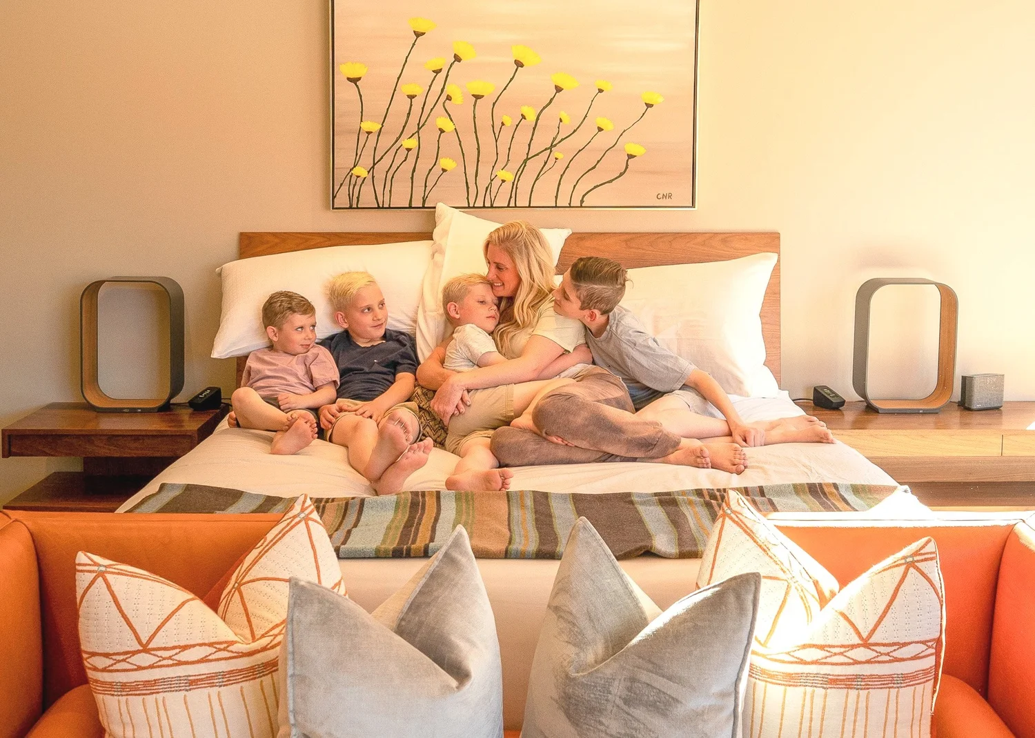 A family sharing a moment together in a guest room.