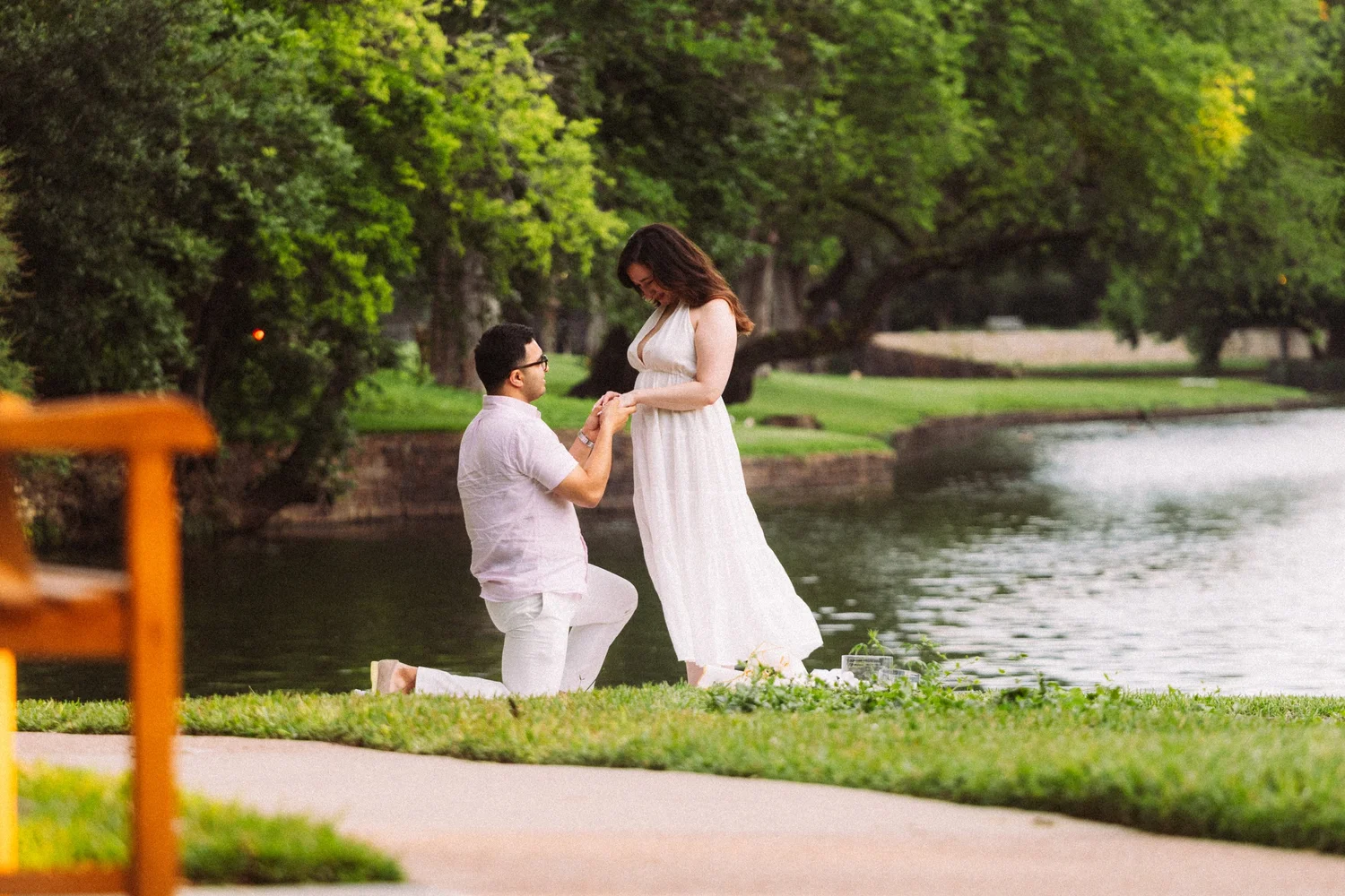 Himanshu proposing to Shelby beside the water in Central Park, New York City