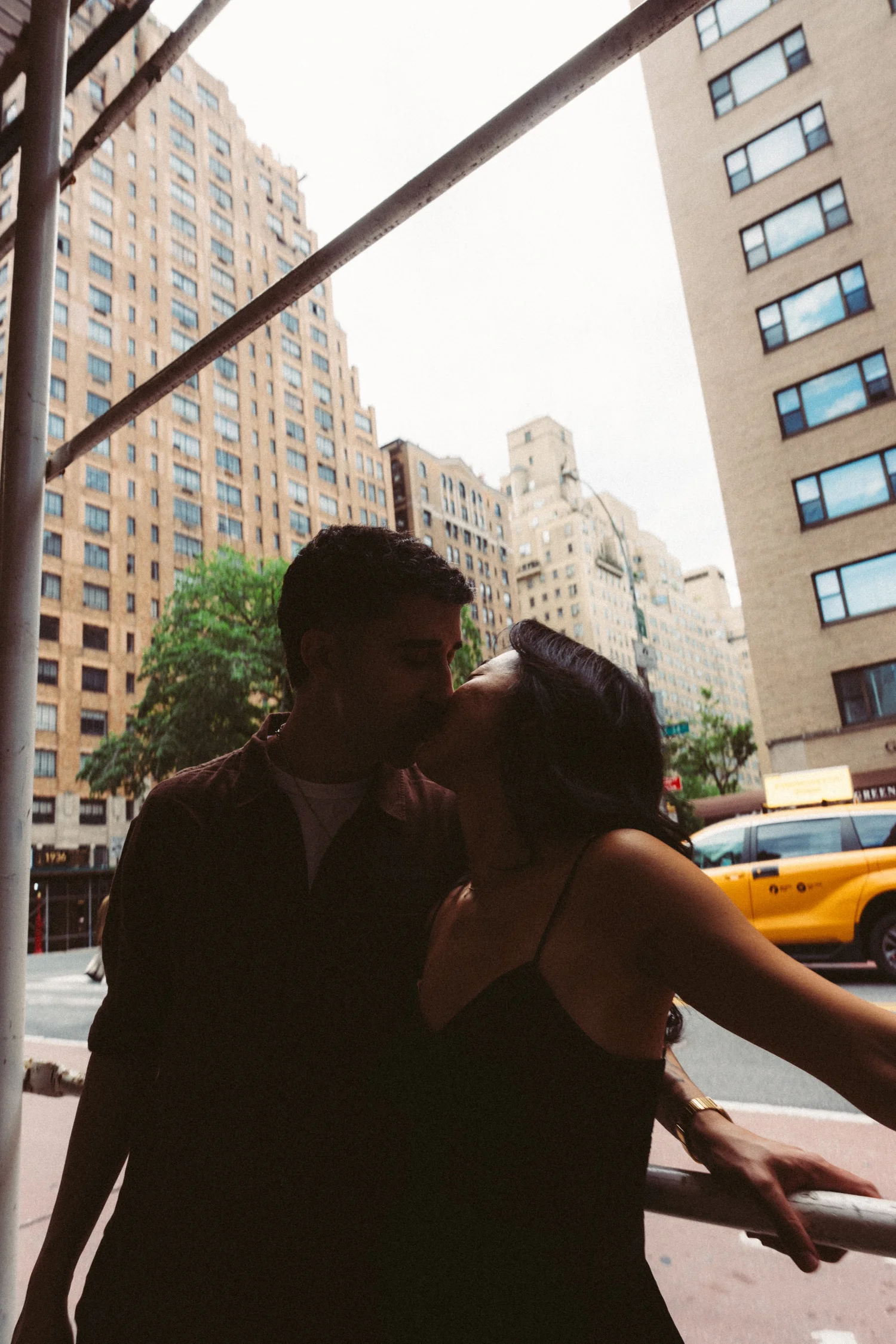 Sophia and Mike sharing a kiss on a New York City sidewalk