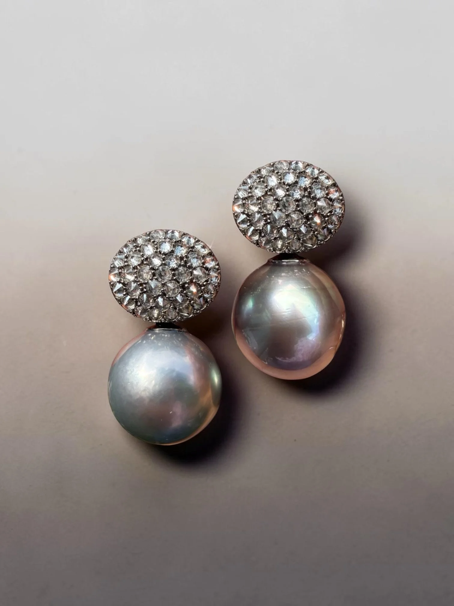 This statement pair of 16.5/17mm pearls attached to inverse set grey diamond clusters is giving me gunmetal vibes. I love modernizing the designs for pearls - marrying texture and smoothness in one.

Oh they are detachable so you can wear the top inv