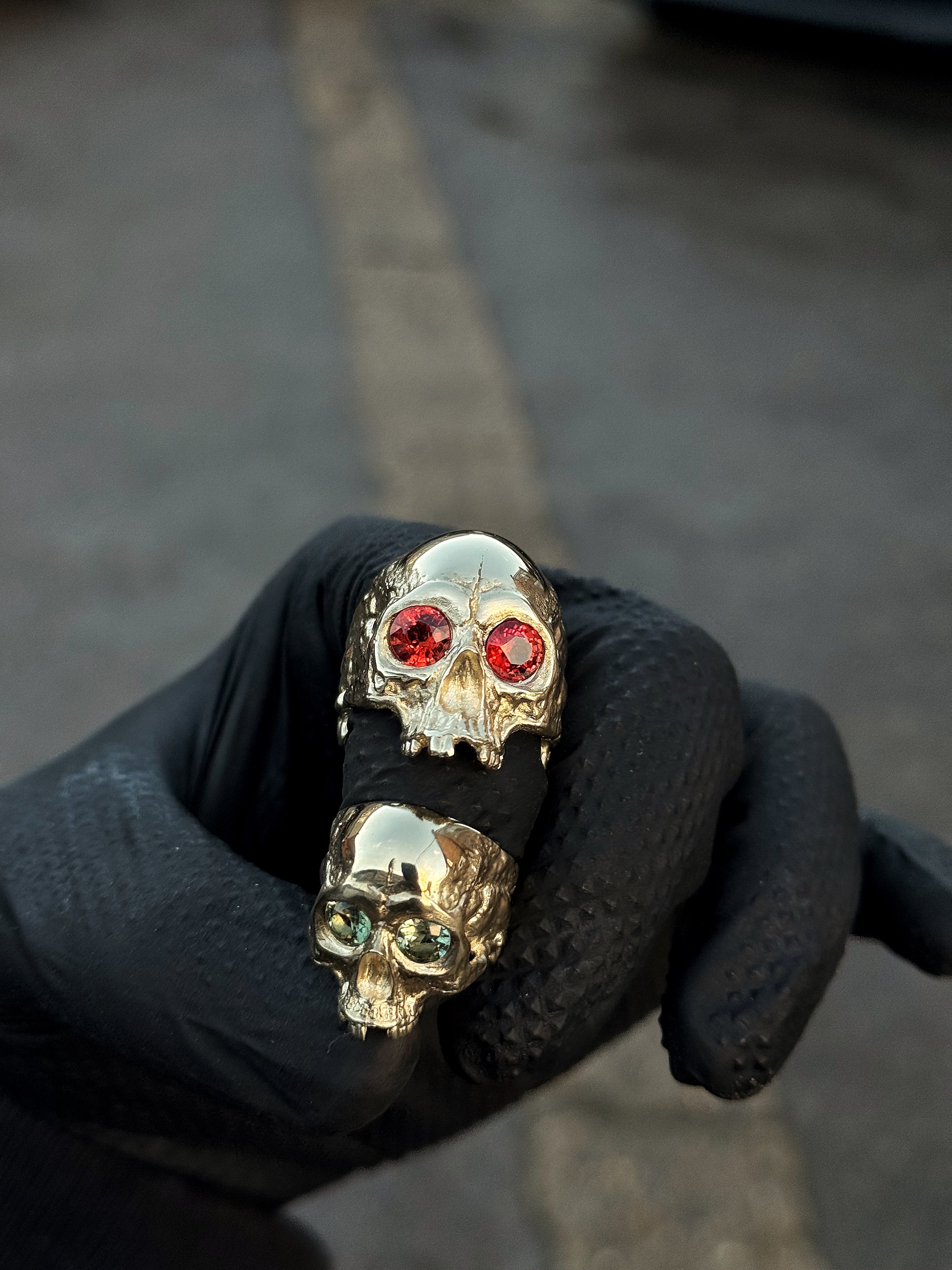 Two Heavy Head 9ct Gold rings, with orange and green sapphires set into the eye sockets. The most beautiful pair of wedding rings.