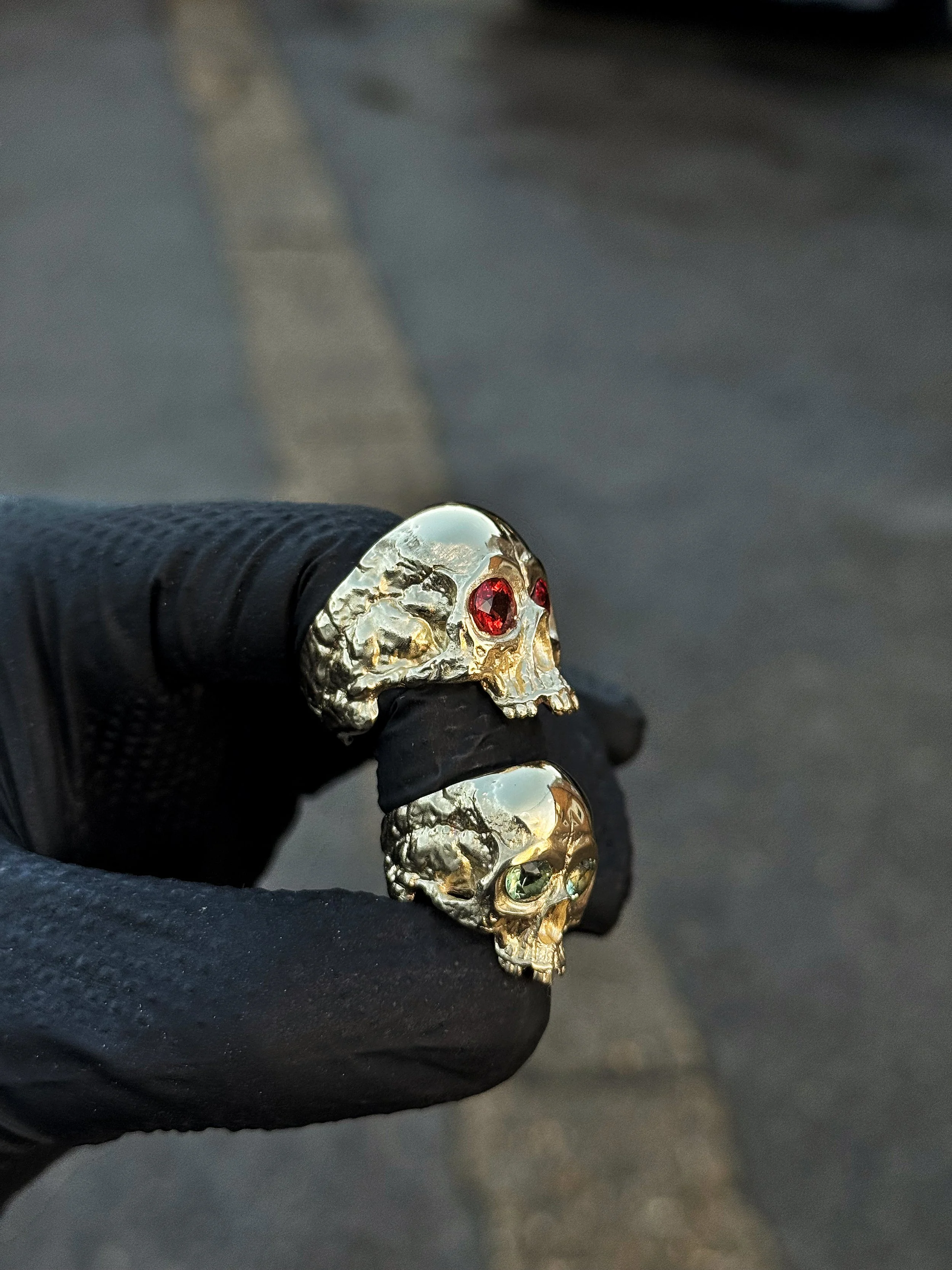 Two Heavy Head 9ct Gold rings, with orange and green sapphires set into the eye sockets. The most beautiful pair of wedding rings.
