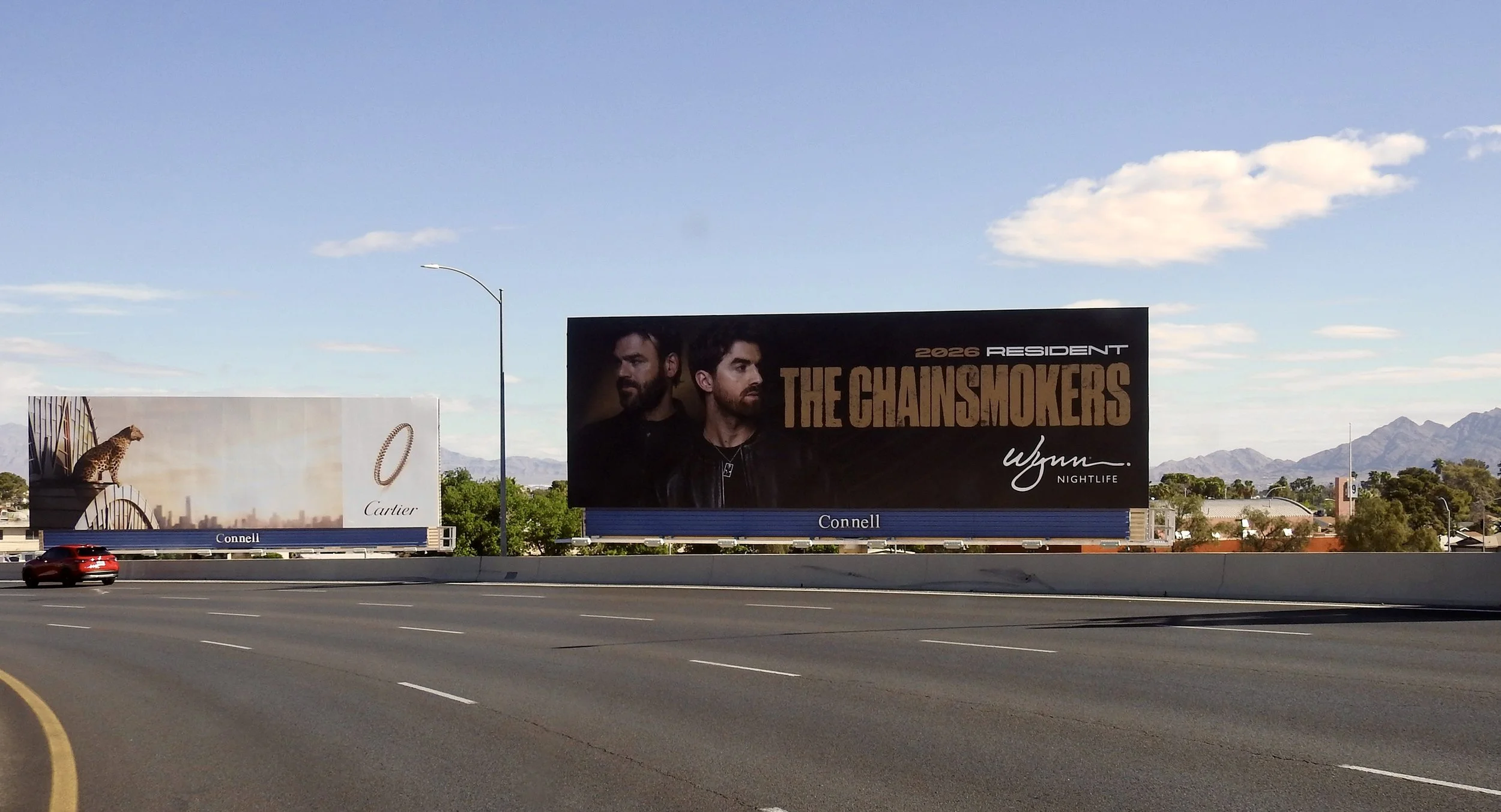 High-impact horizontal billboard on the I-15 corridor featuring The Chainsmokers for their XS Nightclub residency. The creative uses a "hero-shot" aesthetic with a minimalist, high-luxury color palette to stand out against the desert backdrop.