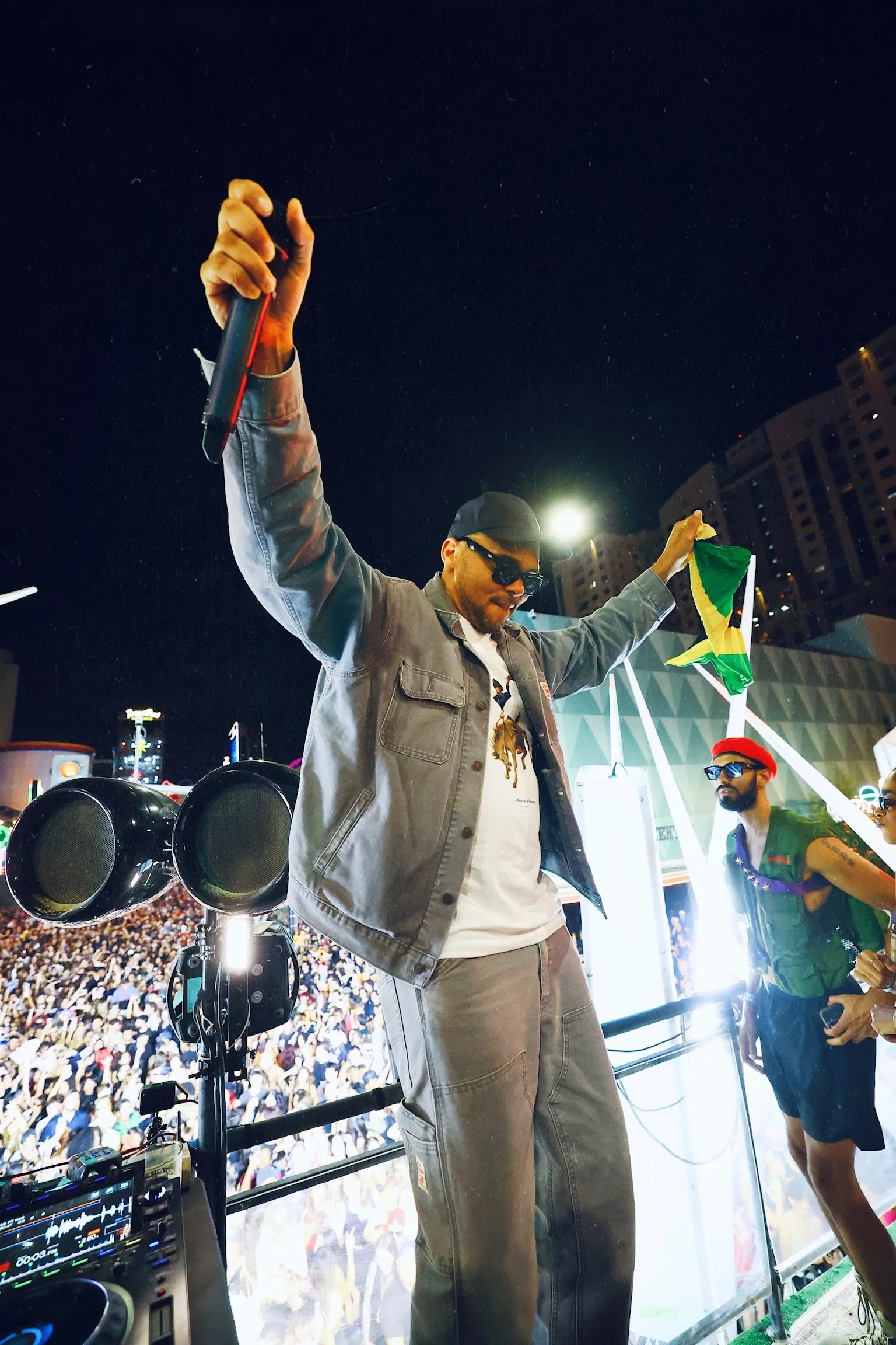 Diplo and Walshy Fire of Major Lazer waving oversized 'Feed The Block' and 'Wynn Nightlife' flags over a massive DTLV crowd, shot by @dmahoneyphoto.