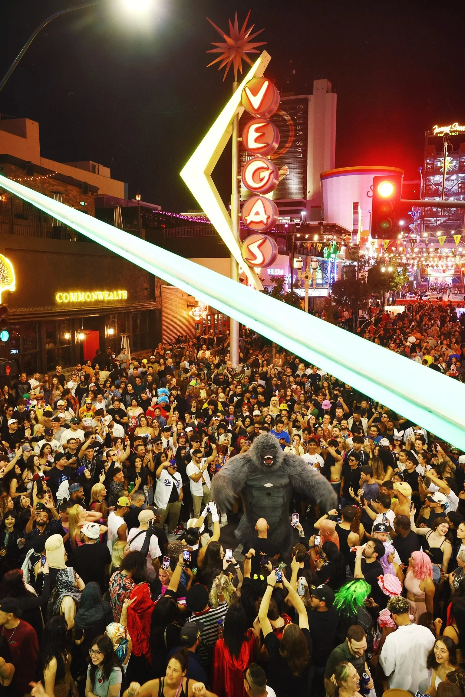 Wide-angle overhead shot of thousands of fans in costume filling the streets of Downtown Las Vegas for the 2026 Feed The Block Halloween event.