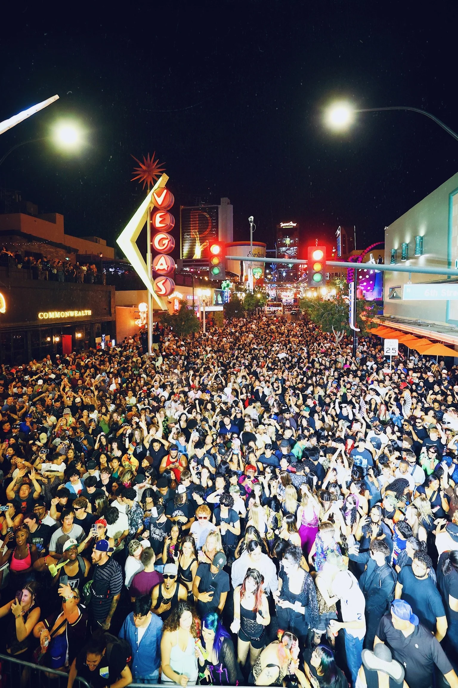 Aerial view of thousands of fans with arms raised during the Major Lazer takeover at Commonwealth, illustrating the scale of Las Vegas block parties.