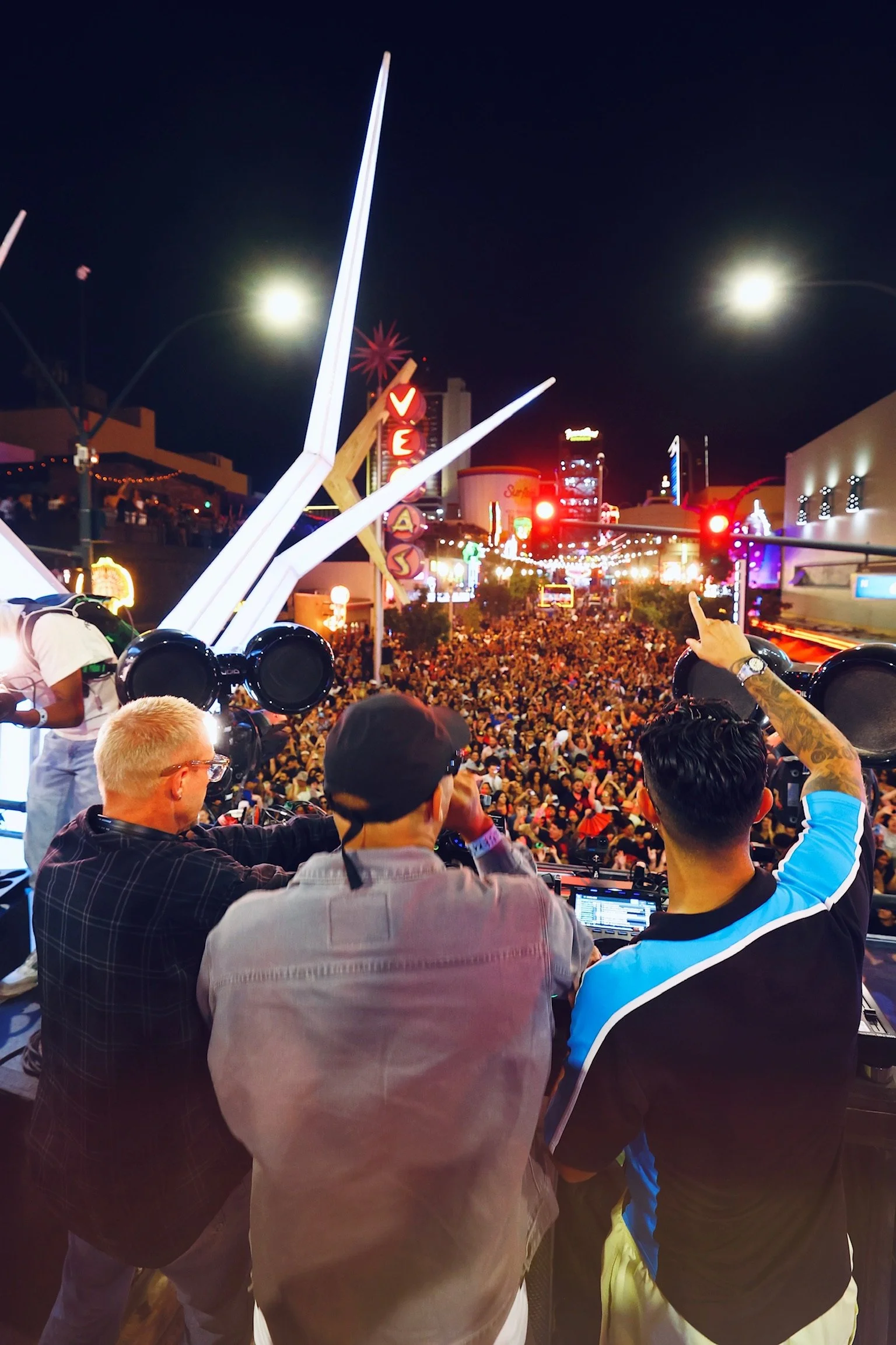 Major Lazer performing live in Downtown Las Vegas, featuring Walshy Fire engaging the audience from the DJ booth during a high-energy 'Feed The Block' set.