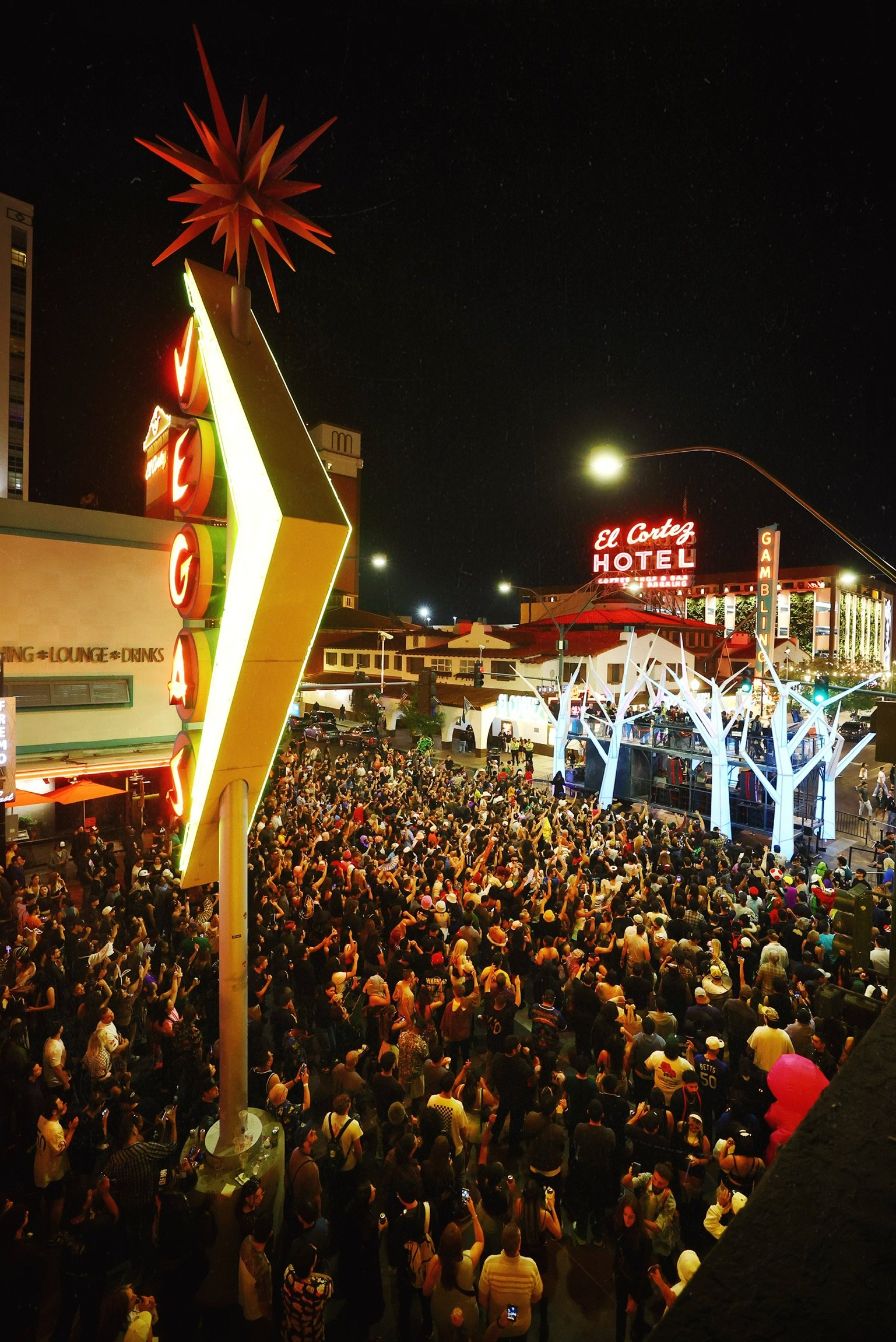 Wide-angle overhead shot of thousands of fans in costume filling the streets of Downtown Las Vegas for the 2026 Feed The Block Halloween event.