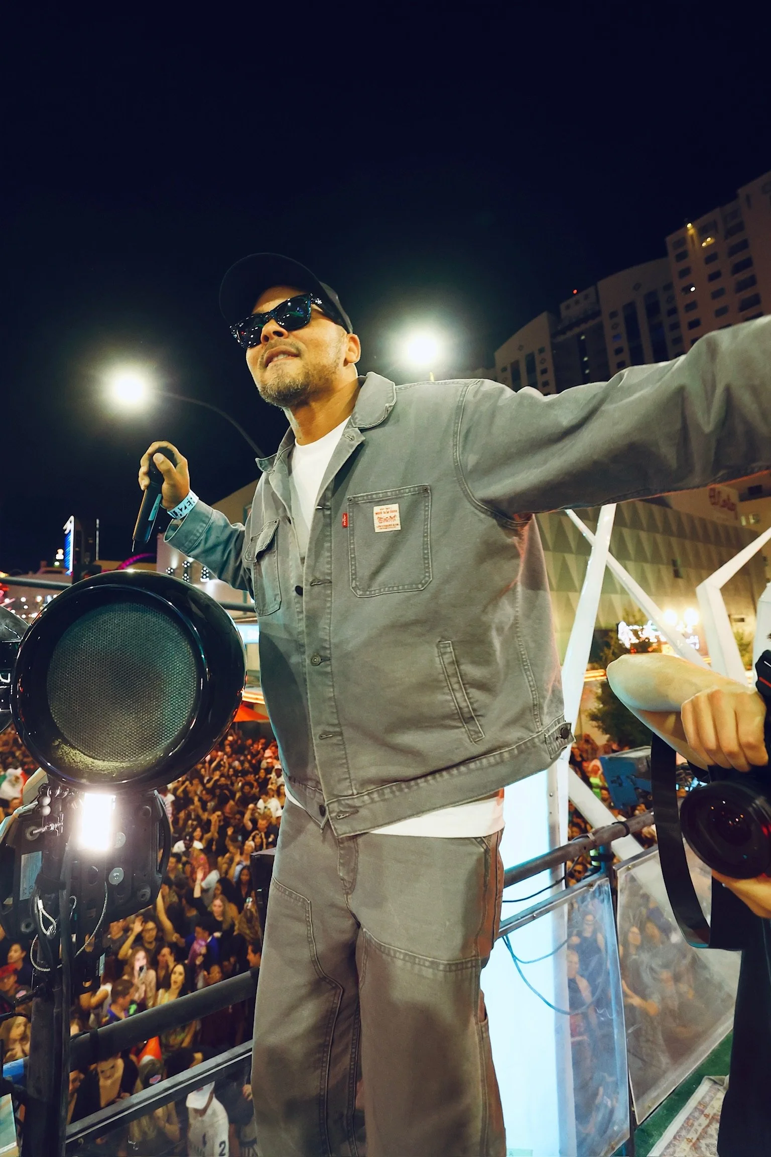 Diplo and Walshy Fire of Major Lazer waving oversized 'Feed The Block' and 'Wynn Nightlife' flags over a massive DTLV crowd, shot by @dmahoneyphoto.