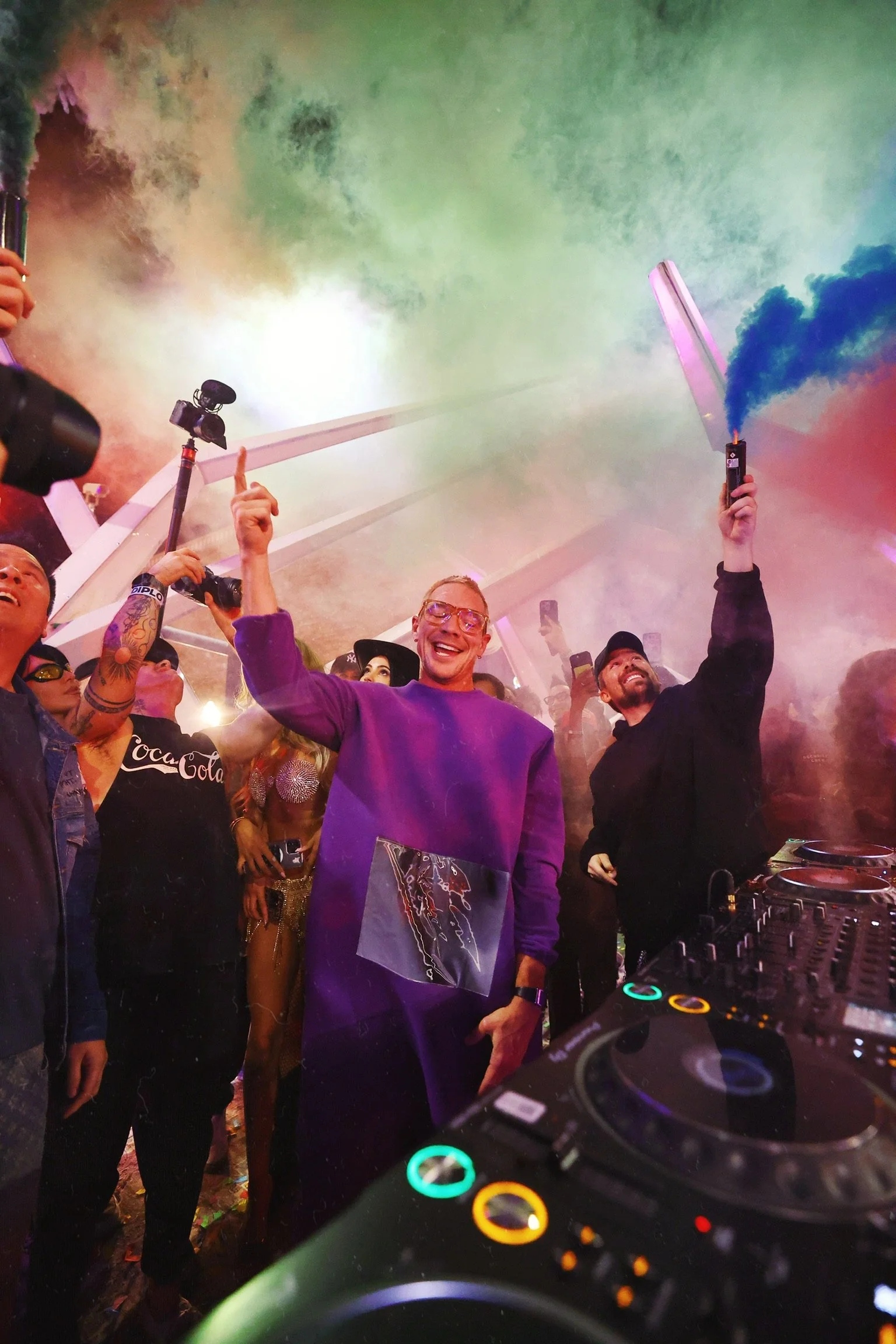 Dramatic stage shot of colorful smoke flares and pyrotechnics during Diplo’s live set, highlighting the high-production value of Downtown Las Vegas block parties.