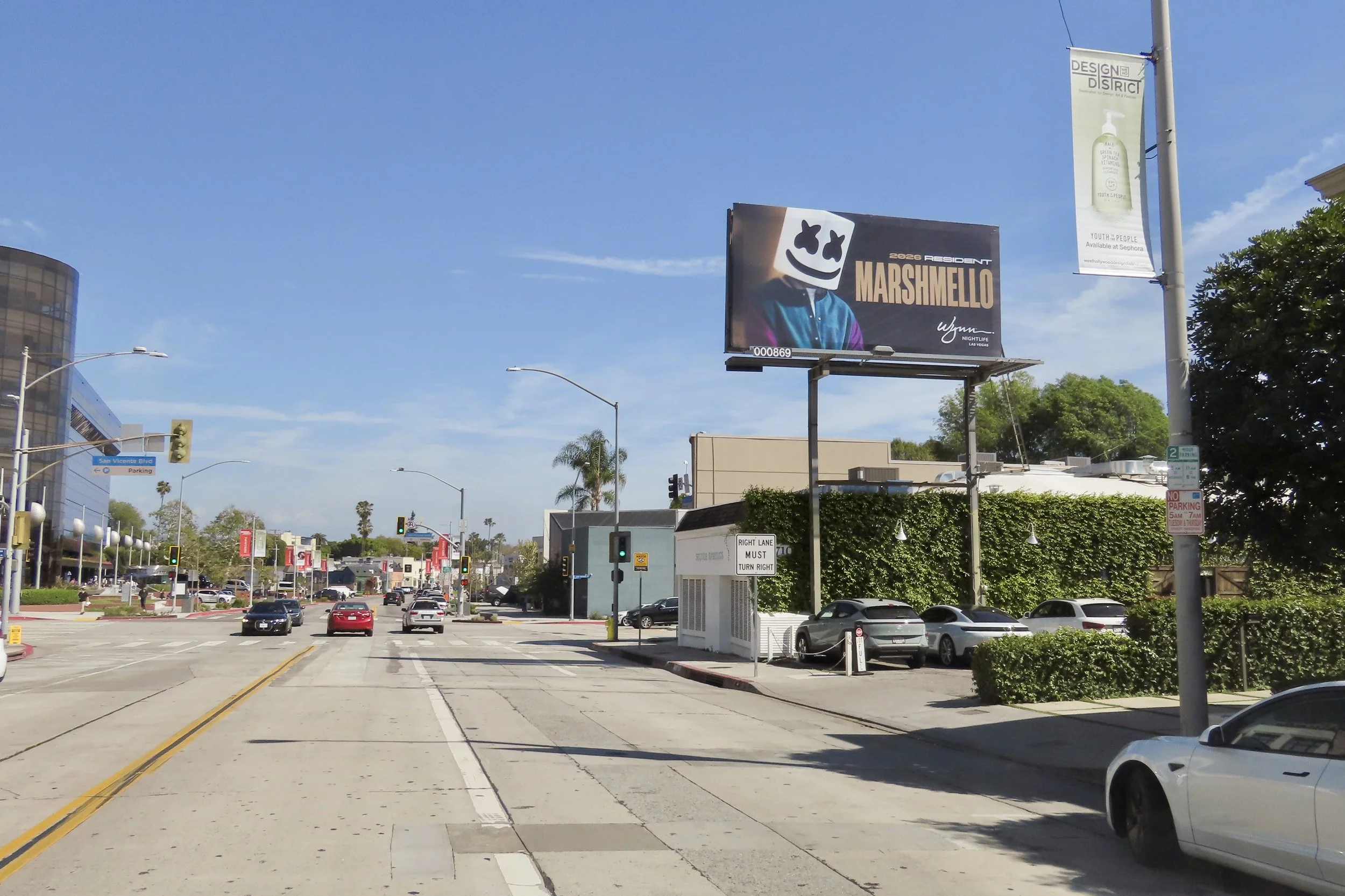 Daytime-optimized billboard showcasing Marshmello’s Encore Beach Club residency. The artwork focuses on bright, vibrant tones that mirror the high-energy pool party atmosphere, positioned at a key traffic junction leading to the Wynn.