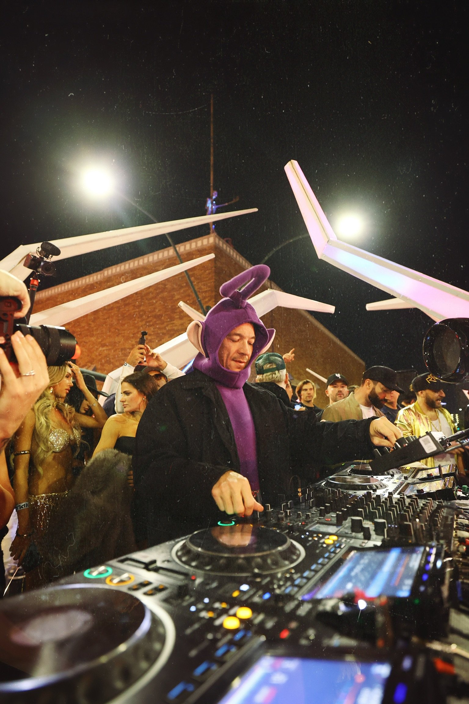 Diplo performing a headline DJ set in a purple Teletubby costume for Feed The Block Halloween in Downtown Las Vegas, photography by @dmahoneyphoto.