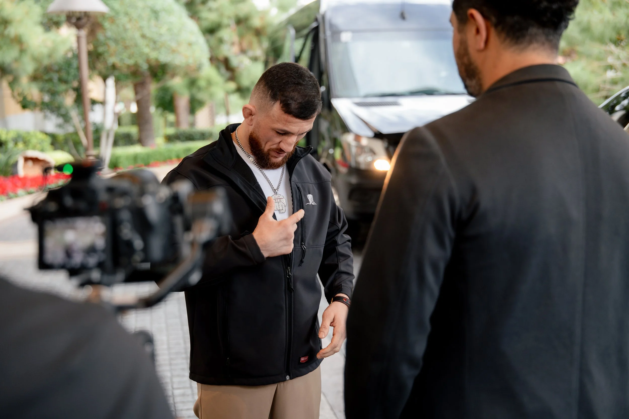 Merab Dvalishvili adjusting his mic before rolls royce door at Encore Tower Suites Wynn Las Vegas