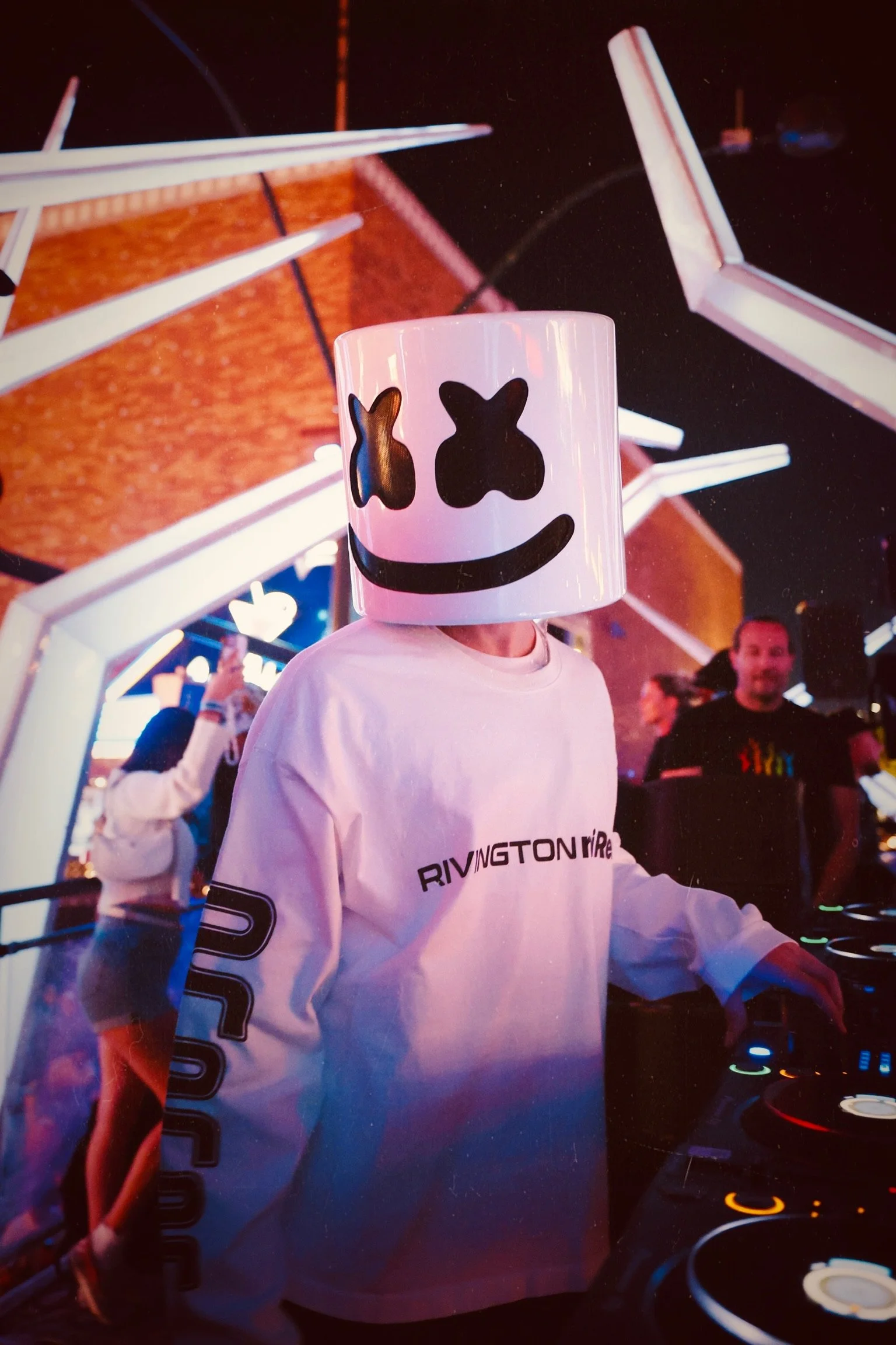 DJ Marshmello performing live for Feed The Block DTLV, featuring the signature Marshmello helmet and white crowd balloons in an immersive Downtown Las Vegas nightlife setting. @dmahoneyphoto