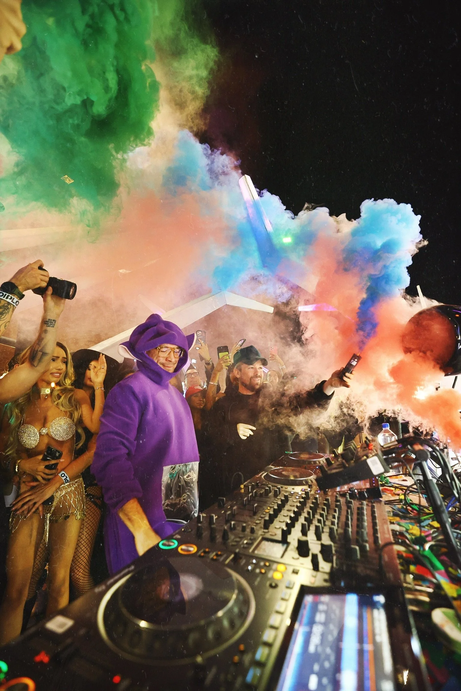 Diplo performing a headline DJ set in a purple Teletubby costume for Feed The Block Halloween in Downtown Las Vegas, photography by @dmahoneyphoto.