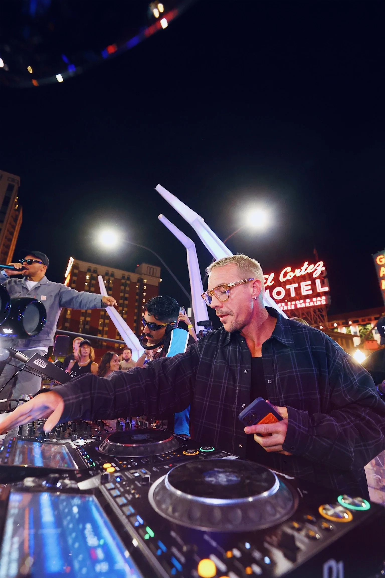 Major Lazer performing live in Downtown Las Vegas, featuring Walshy Fire engaging the audience from the DJ booth during a high-energy 'Feed The Block' set.