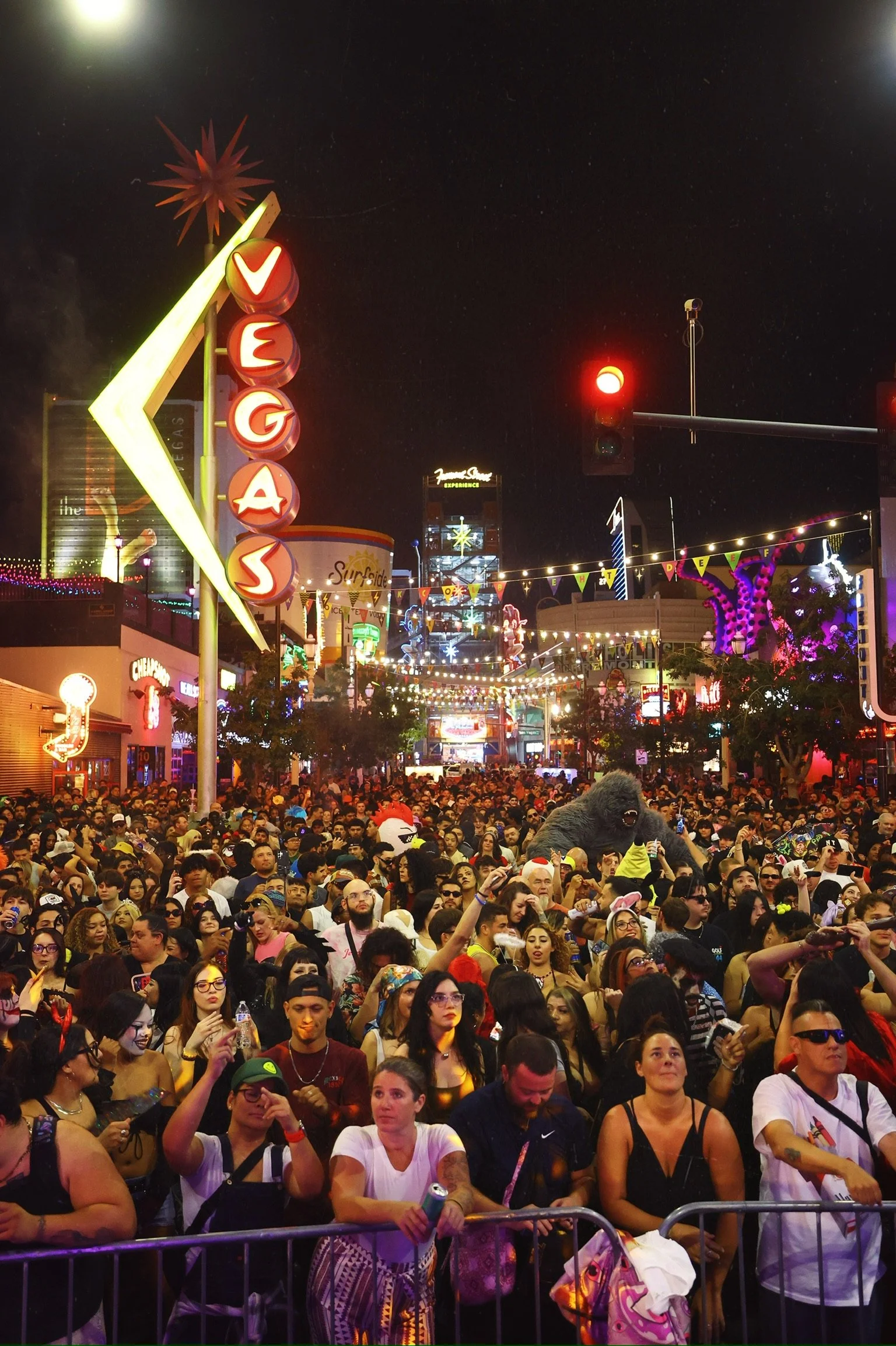 Neon 'Vegas' signs illuminating a packed Fremont Street during the Feed The Block Halloween takeover, showcasing DTLV’s iconic urban nightlife aesthetic.