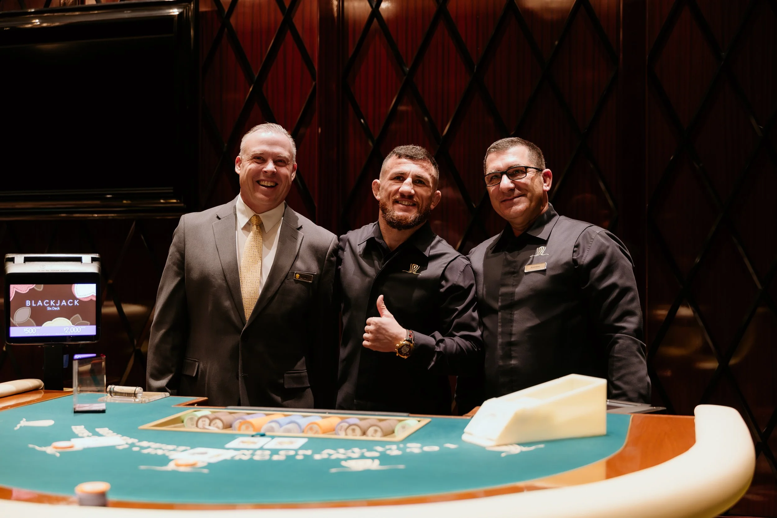On Set with Merab Dvalishvili inside the Encore Poker private room taking a photo with Wynn employees.