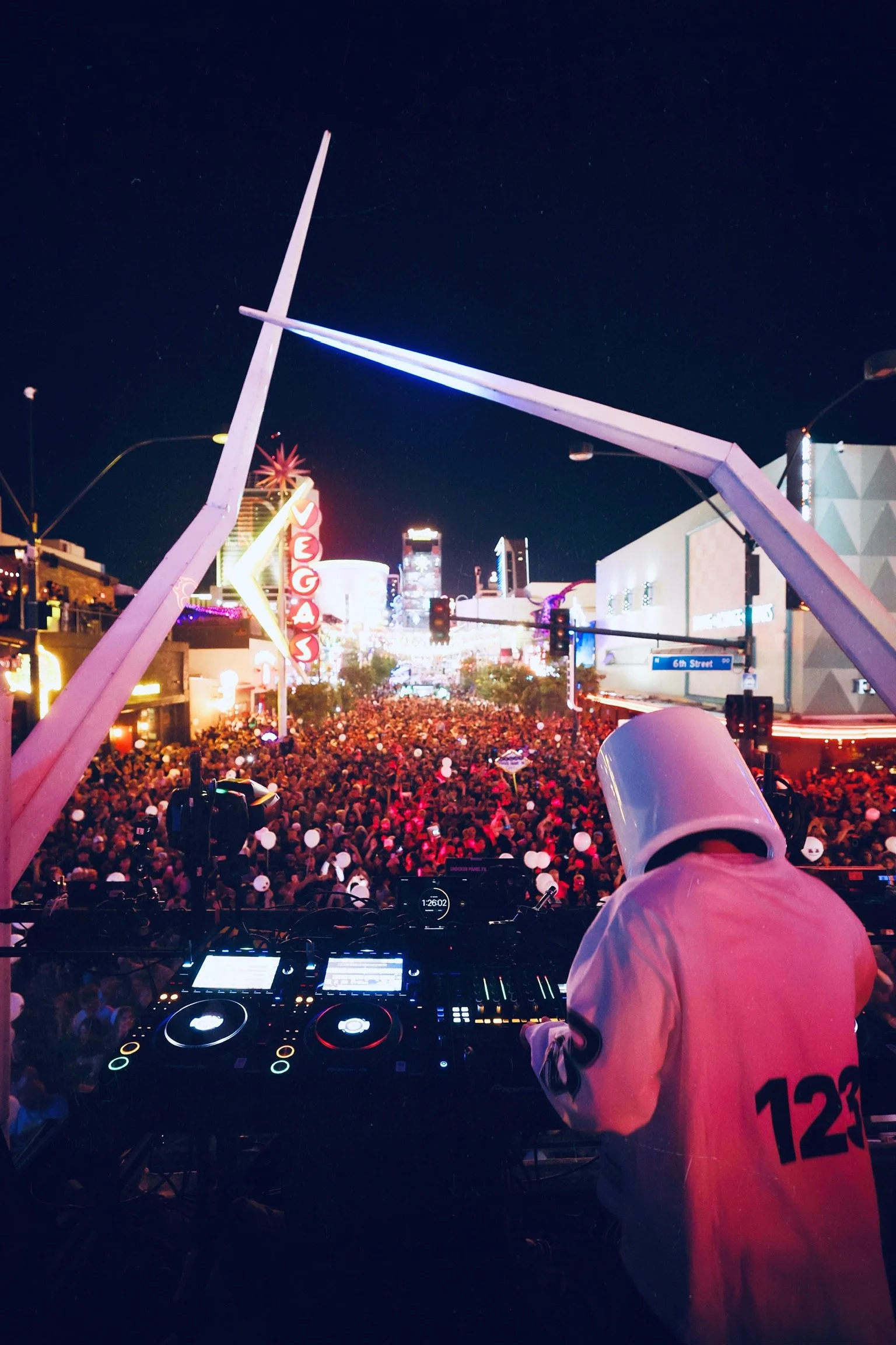 DJ Marshmello performing live for Feed The Block DTLV, featuring the signature Marshmello helmet and white crowd balloons in an immersive Downtown Las Vegas nightlife setting. @dmahoneyphoto
