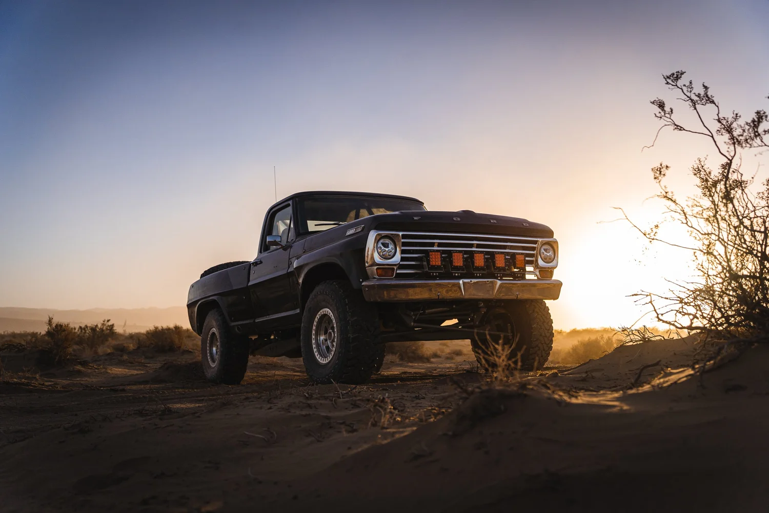 Off-road pickup truck at sunset