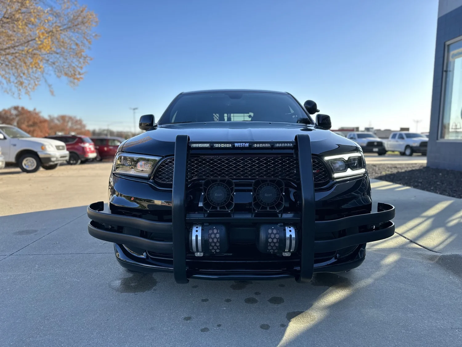 Black police Dodge Durango with push bumper and integrated warning lighting outside the Multiplicity facility
