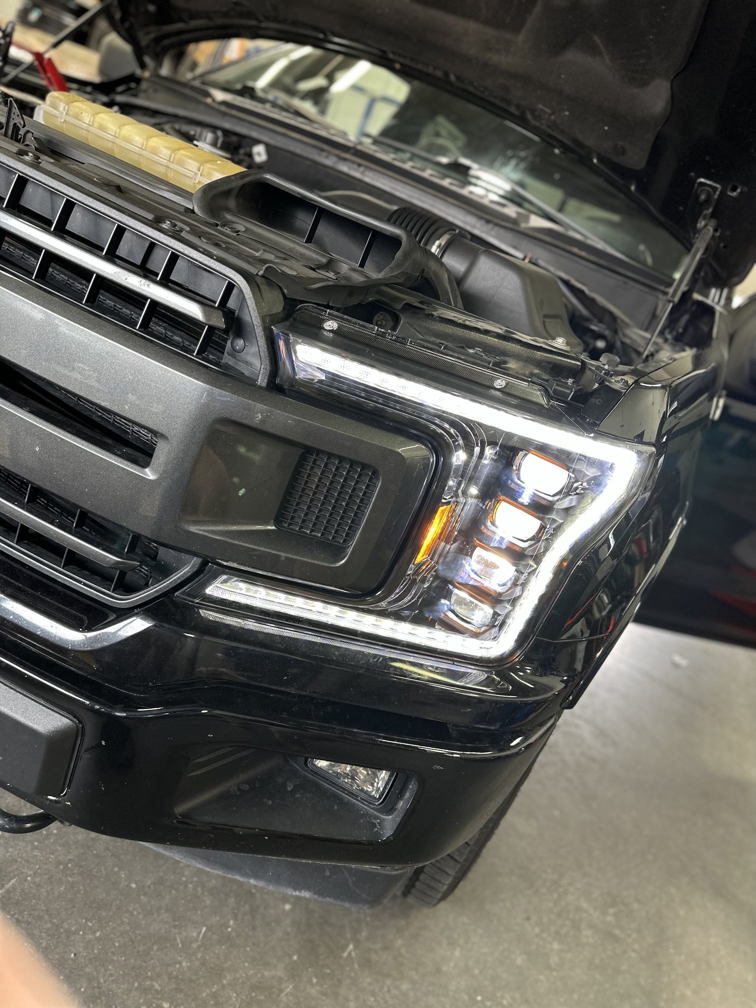Police vehicle front lighting system being serviced in a workshop