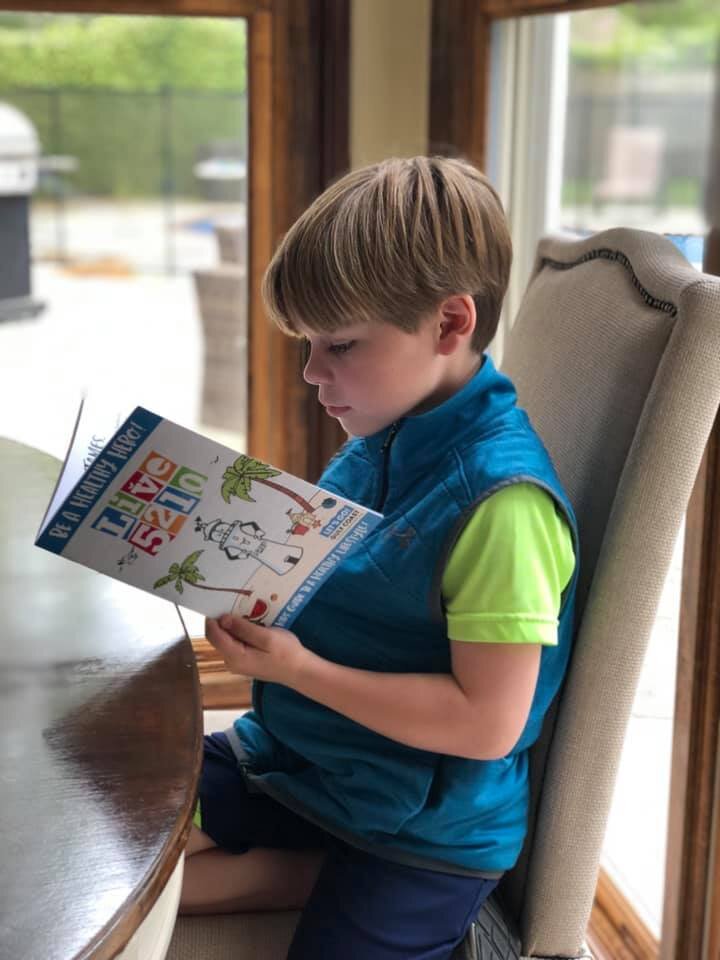 Kid Reading LGGC Activity Book.jpg