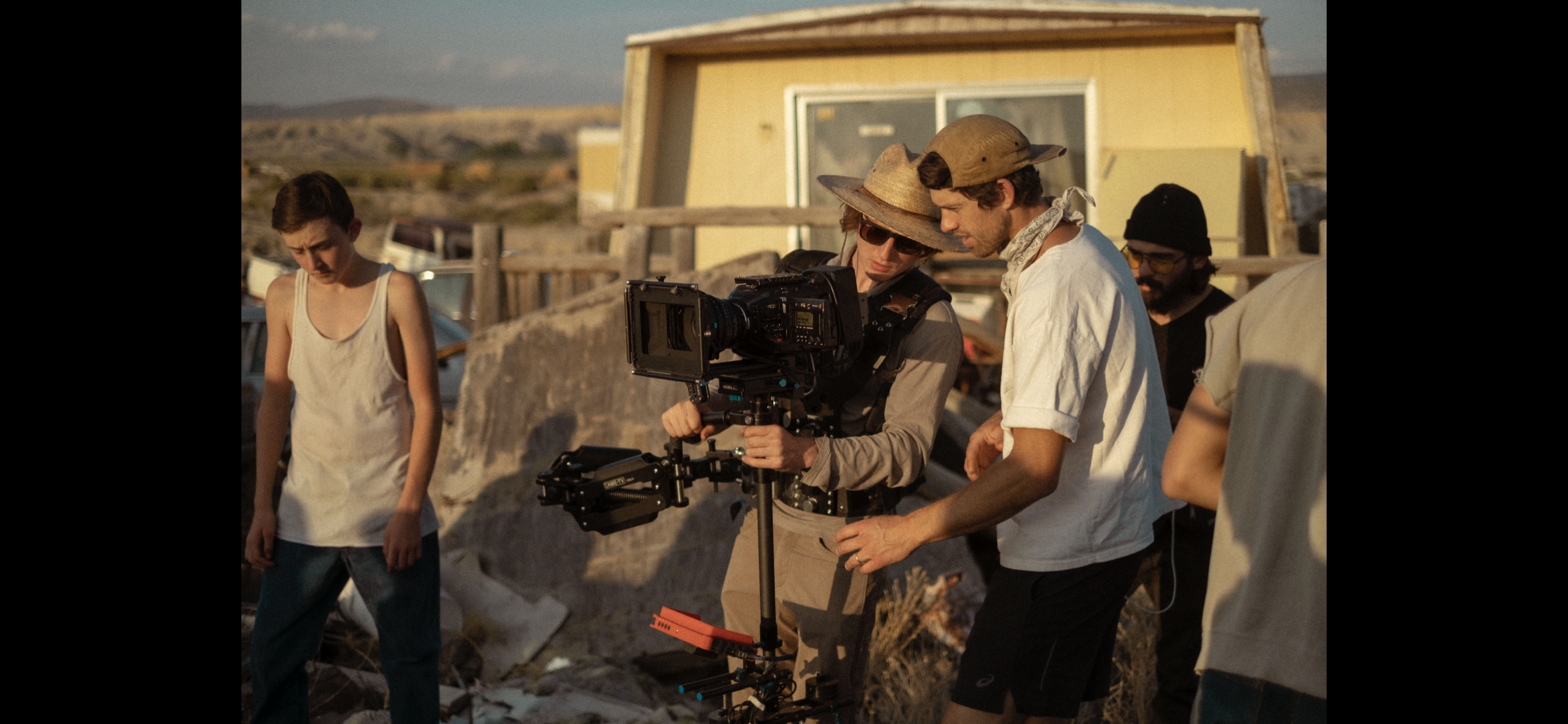 Two-person camera crew operating a cinema rig during an outdoor brand production.