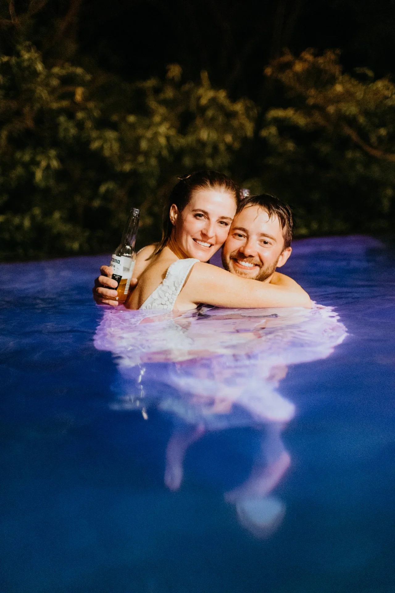 Wedding at Tamarindo couple enjoying jumping in the pool