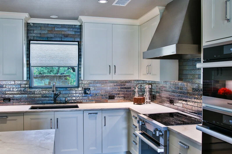 Throughout the entirety of the kitchen are custom-made cabinets from Downsview Kitchens. The white glossy finish gives off a clean and crisp look, and makes for the perfect backdrop for some of the bolder choices throughout the room.&nbsp;
