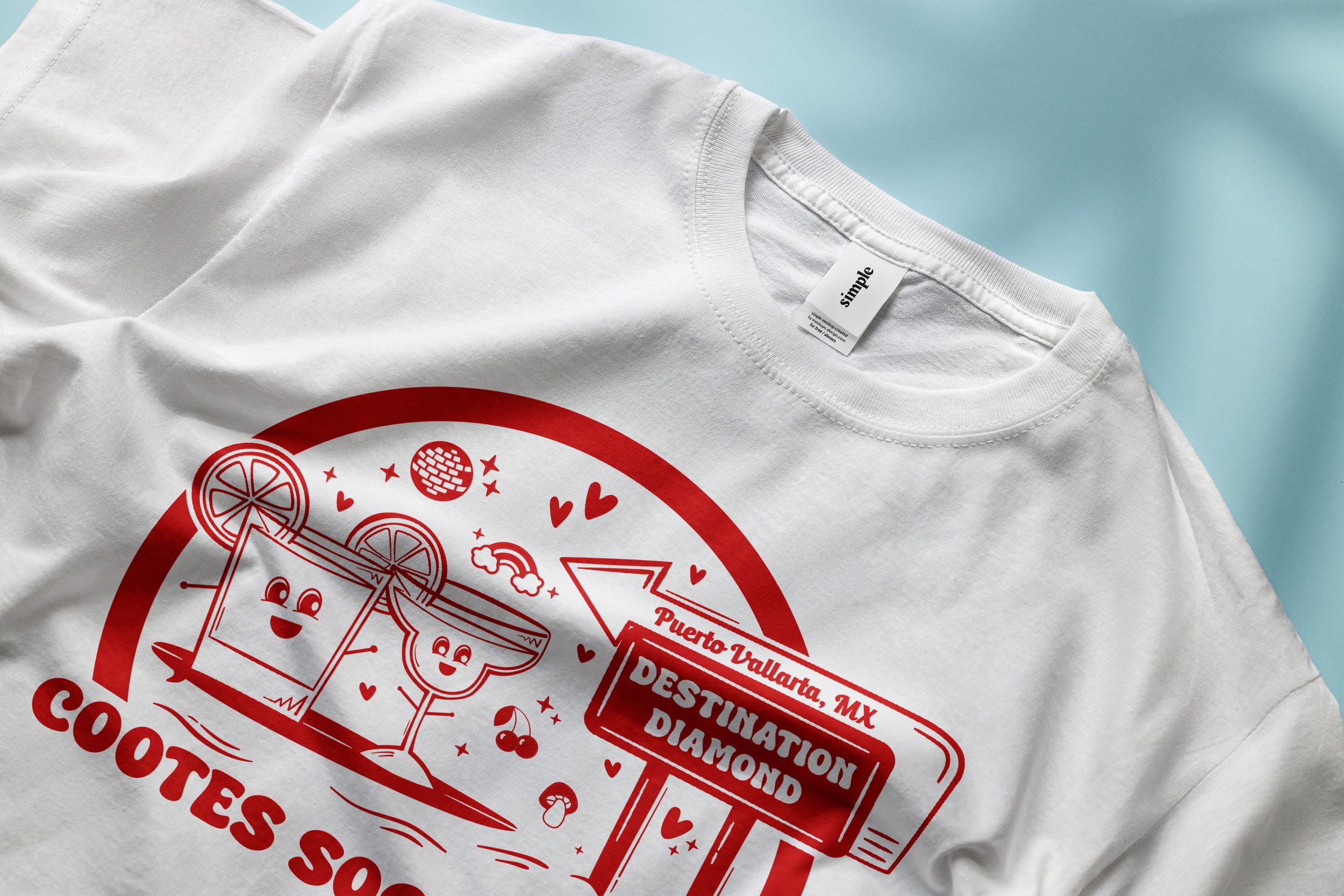A white T-shirt with a red graphic design featuring cartoon-style coasters with smiling faces, a drink with cherries, hearts, stars, and a sign indicating Puerto Vallarta, Mexico as a destination, on a light blue background.