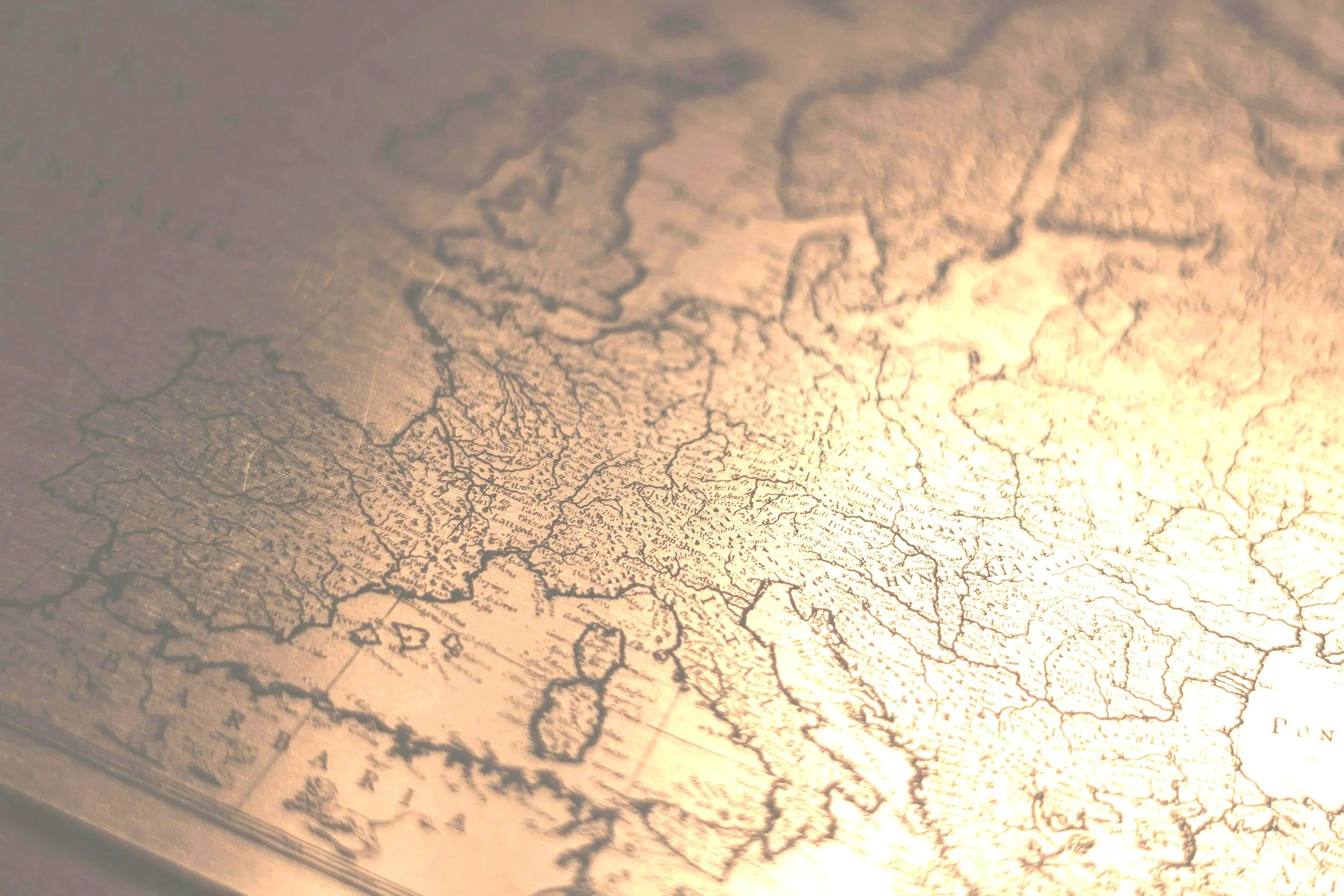 Close-up of an old historical map showing detailed lines and text of geographic locations.