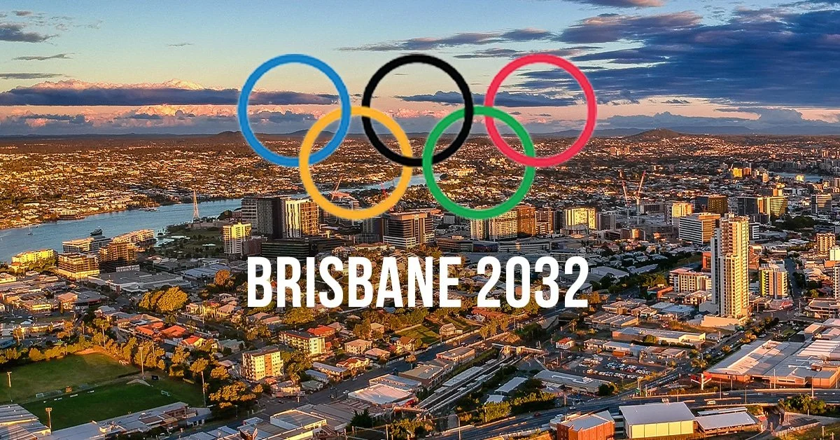 Brisbane 2032 Olympic skyline view at sunset with Olympic rings, promoting Airhome property investment and short-term rental opportunities