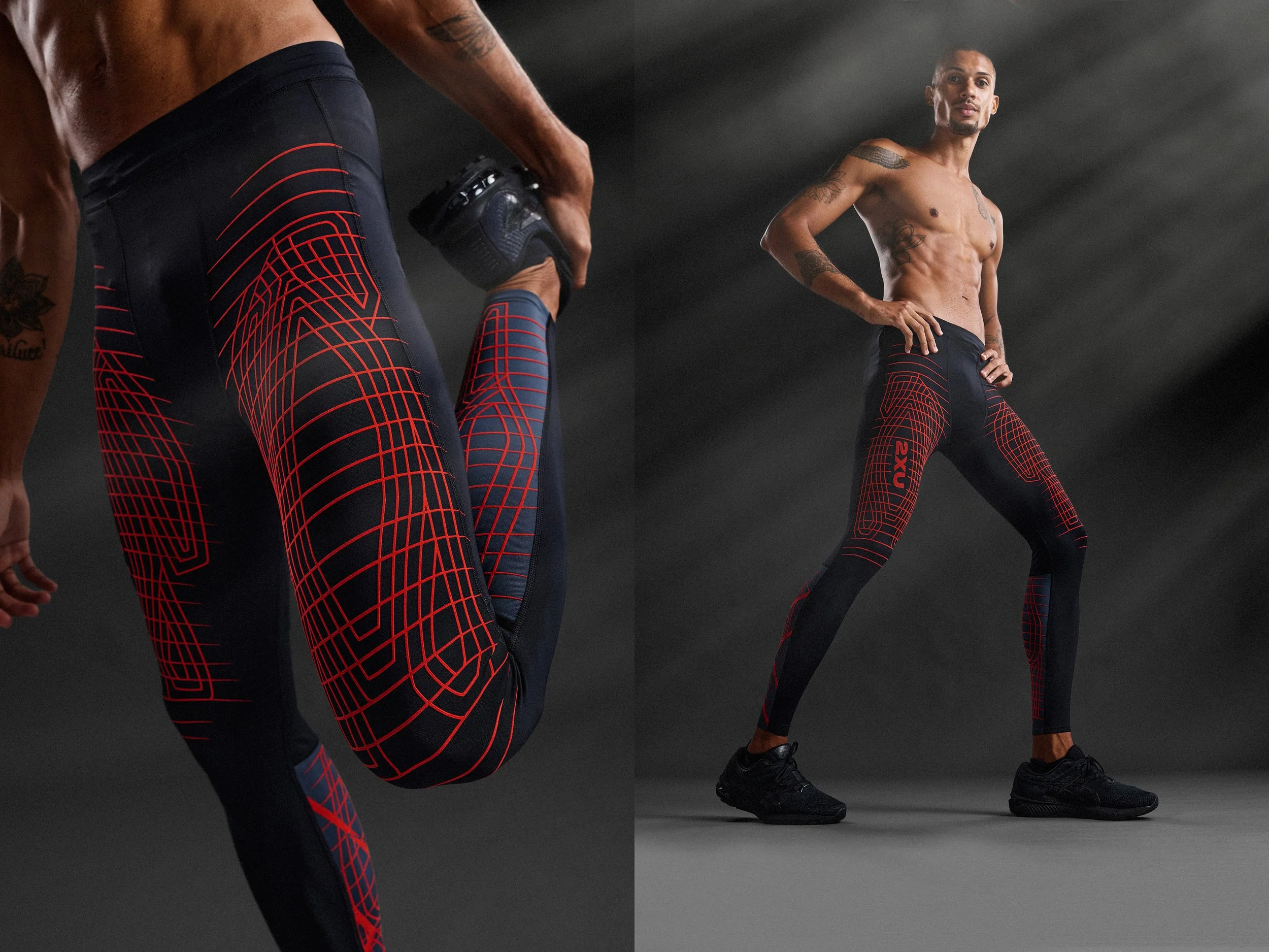 Two shirtless men in black and red athletic leggings with geometric patterns, one holding a weight and the other standing with hands on hips, in a dark indoor gym or studio.