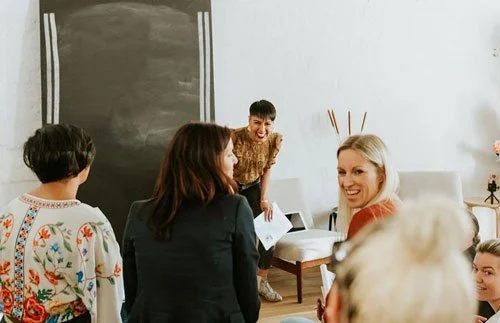 Sharon addressing a group of female participants at an Invincible Co networking event