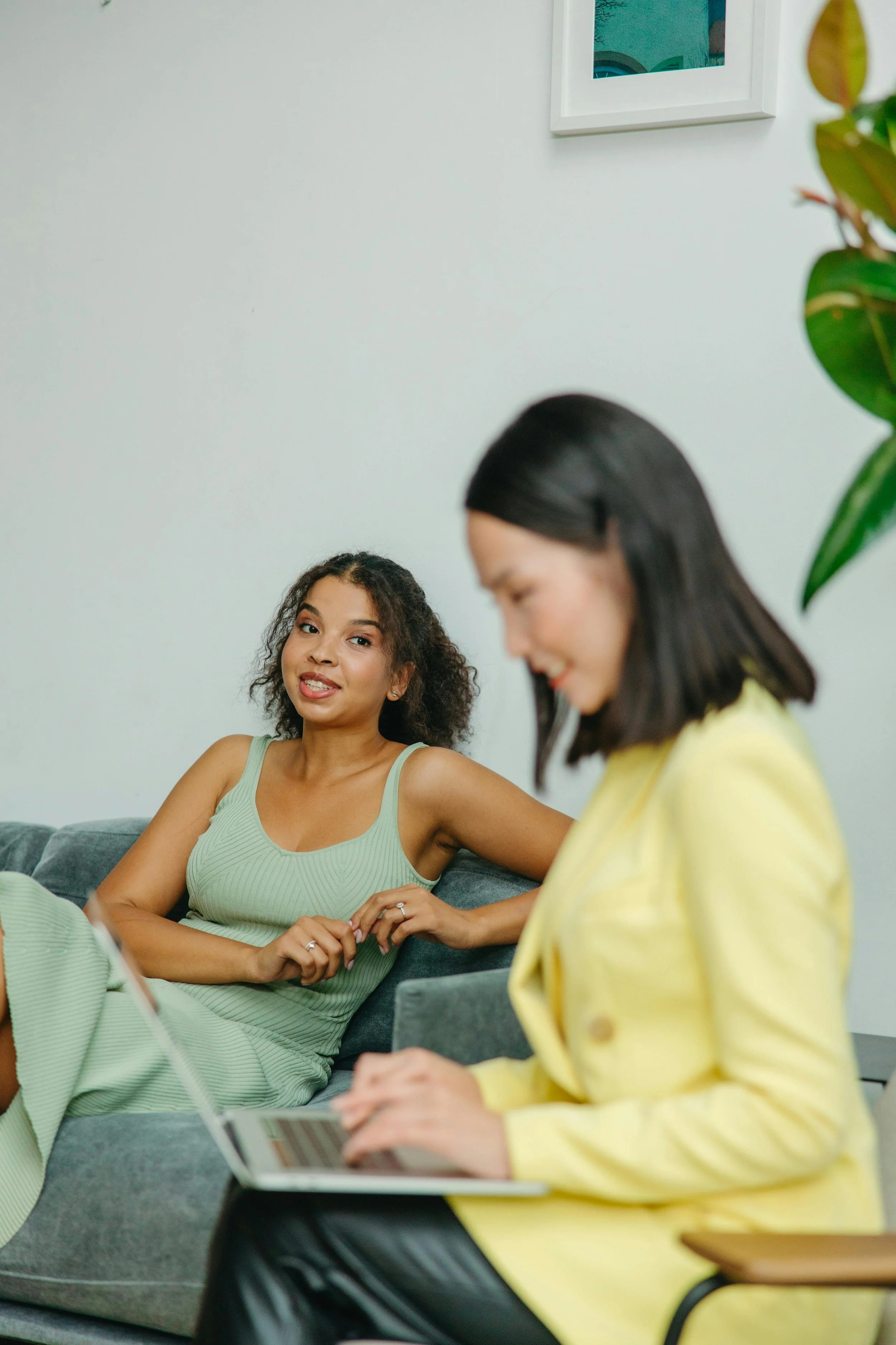 Two participants of The Invincible Co Women's Community engaged in conversation