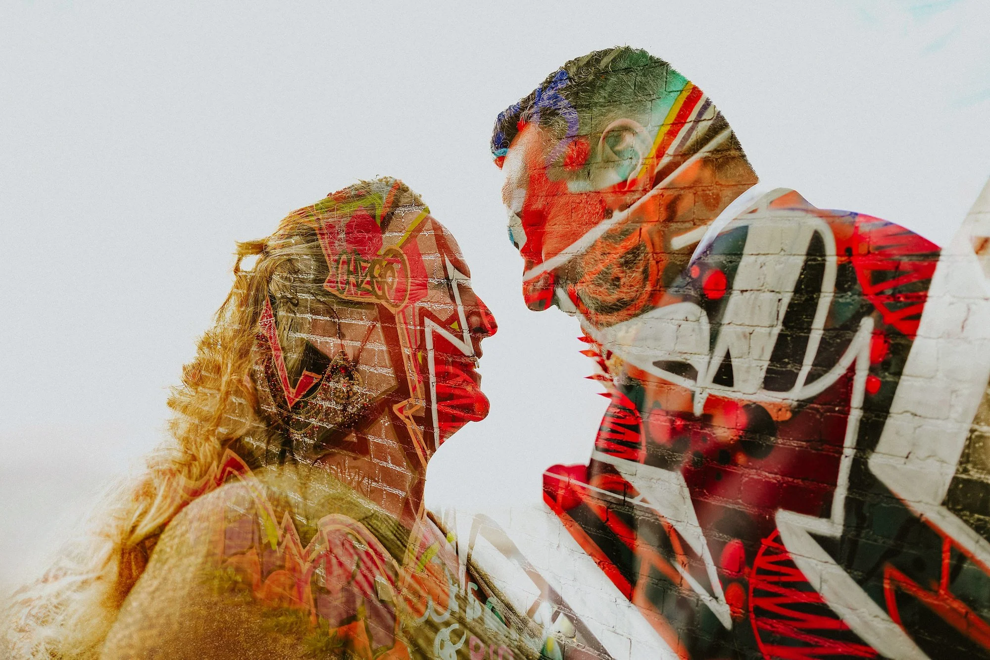 A double exposure of Digbeth graffiti mixed with a portrait of a Bride and groom. Colourful fusion wedding on the streets of Birmingham.