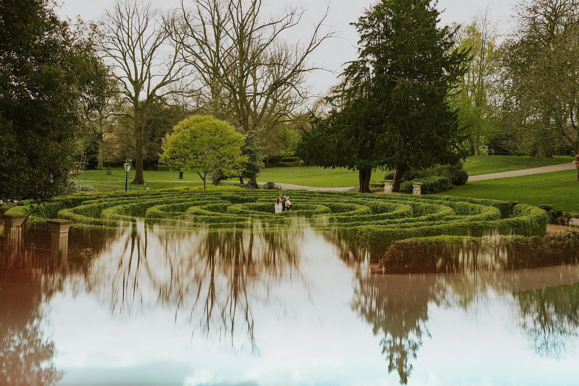 Lincoln Arboretum maze. A family stand right in the middle. Symmetry surrealism & soul in Lincoln.