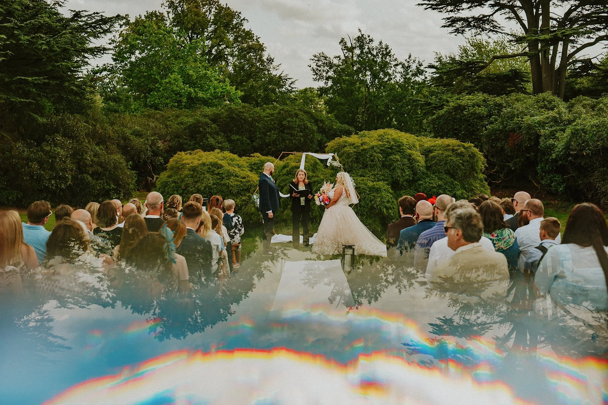 A Yorkshire Sculpture Park wedding ceremony. Beautiful summer greens and blue skies amidst the spectacular grounds as the couple say their I do's.