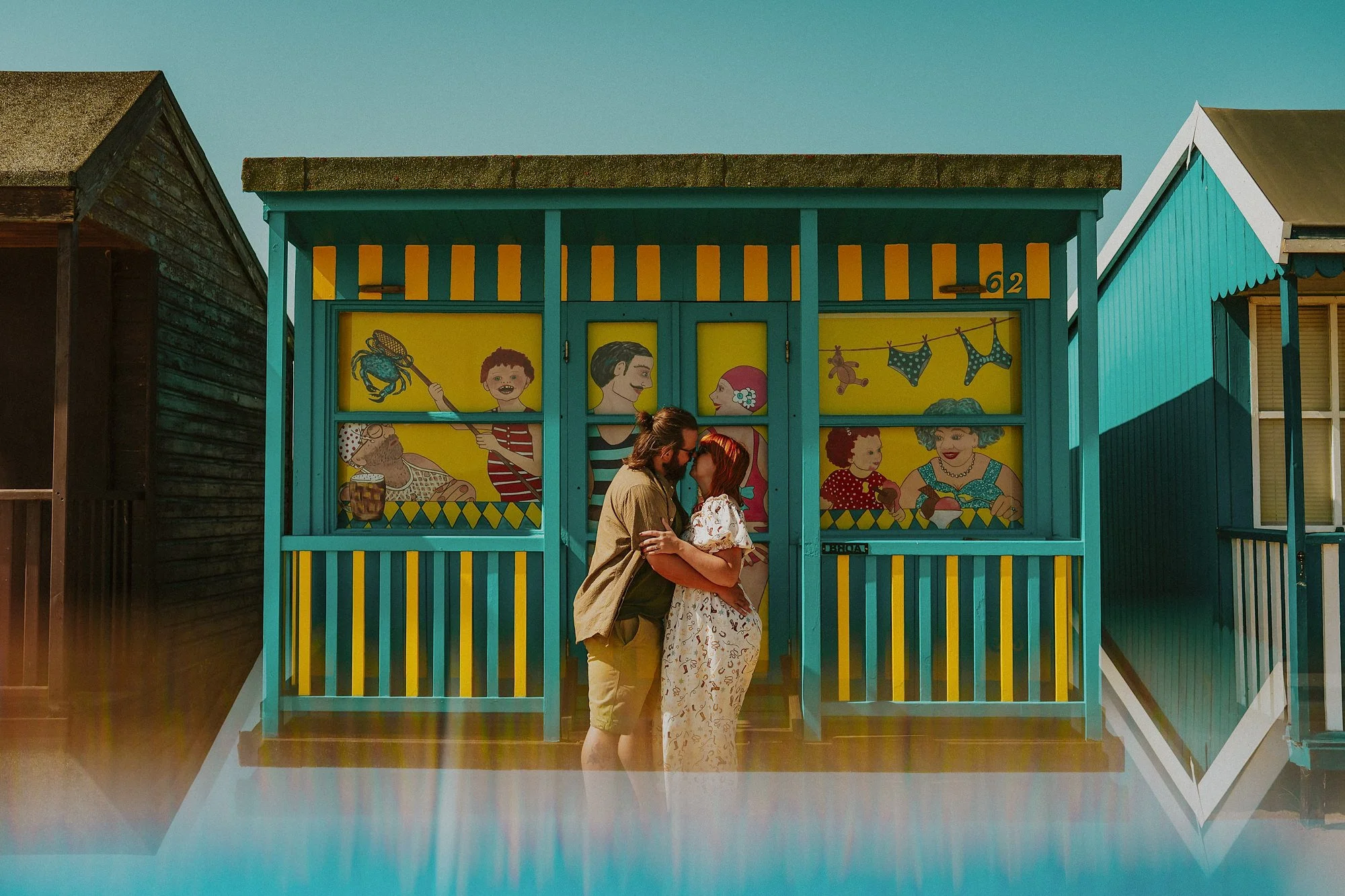The eclectic beach huts of sandilands provide the backdrop of this Lincolnshire Coast maternity shoot. The mum & dad to be embrace amidst colourful seaside.