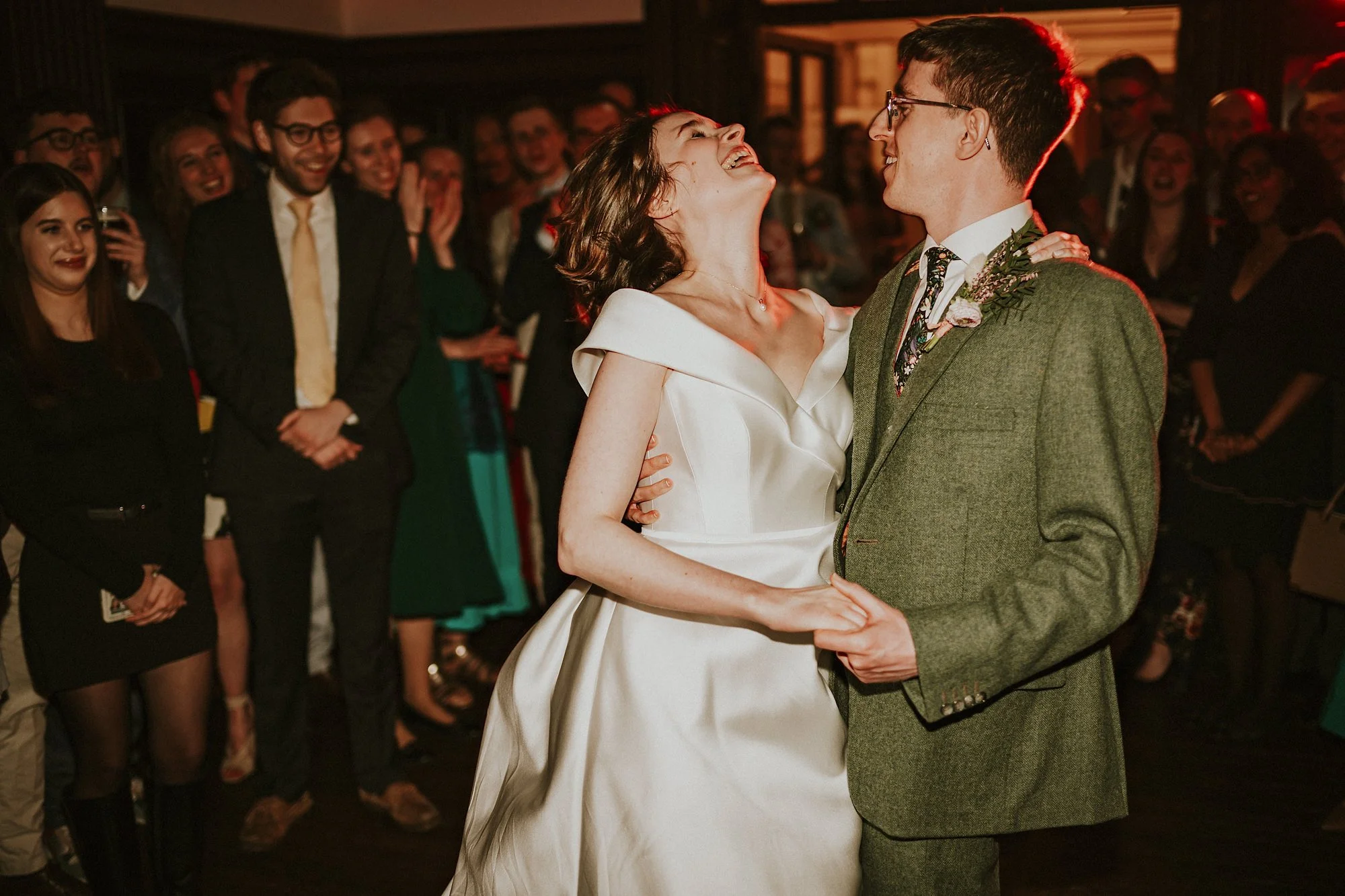 A first dance moment as the Bride and Groom laugh amidst onlooking guest in this Wortley Hall wedding.