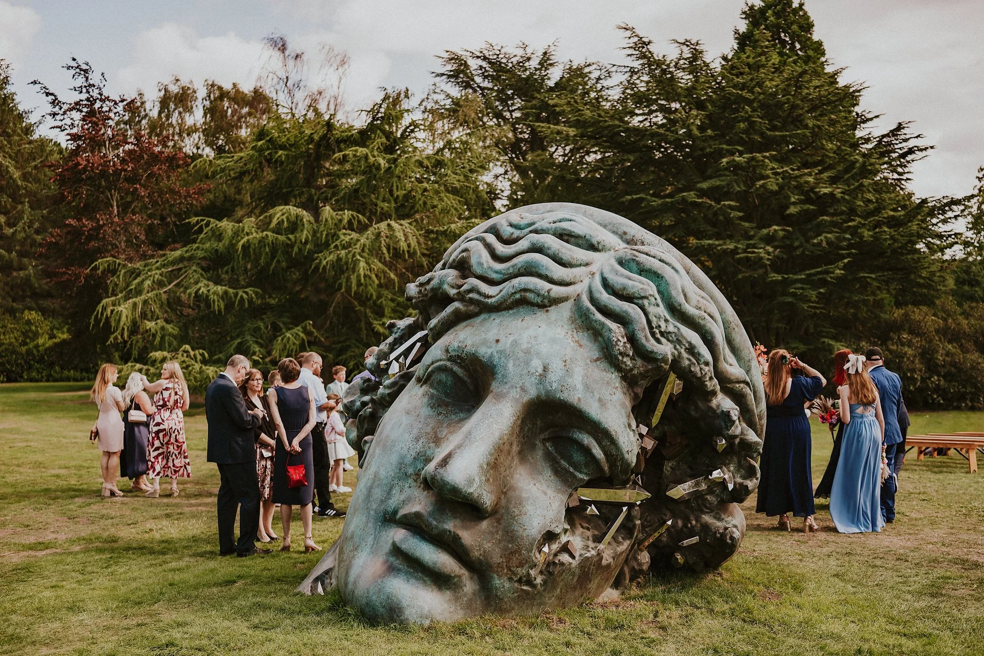 A wedding ceremony at Yorkshire Sculpture Park amidst Daniel Arsham's giant head sculpture.