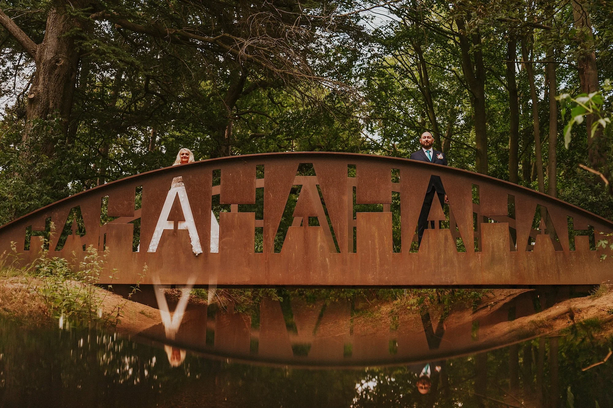 The hahaha bridge at Yorkshire Sculpture Park with a Bride and Groom either side for their wedding photos.