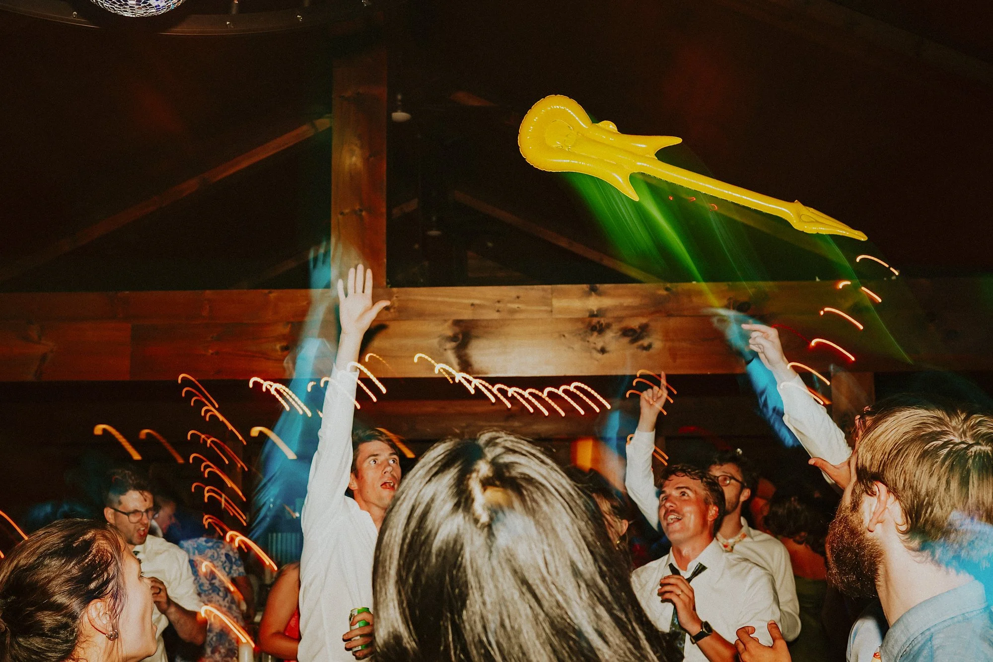 A yellow inflatable guitar is thrown high inside the taproom at Lake Bomoseen Lodge.